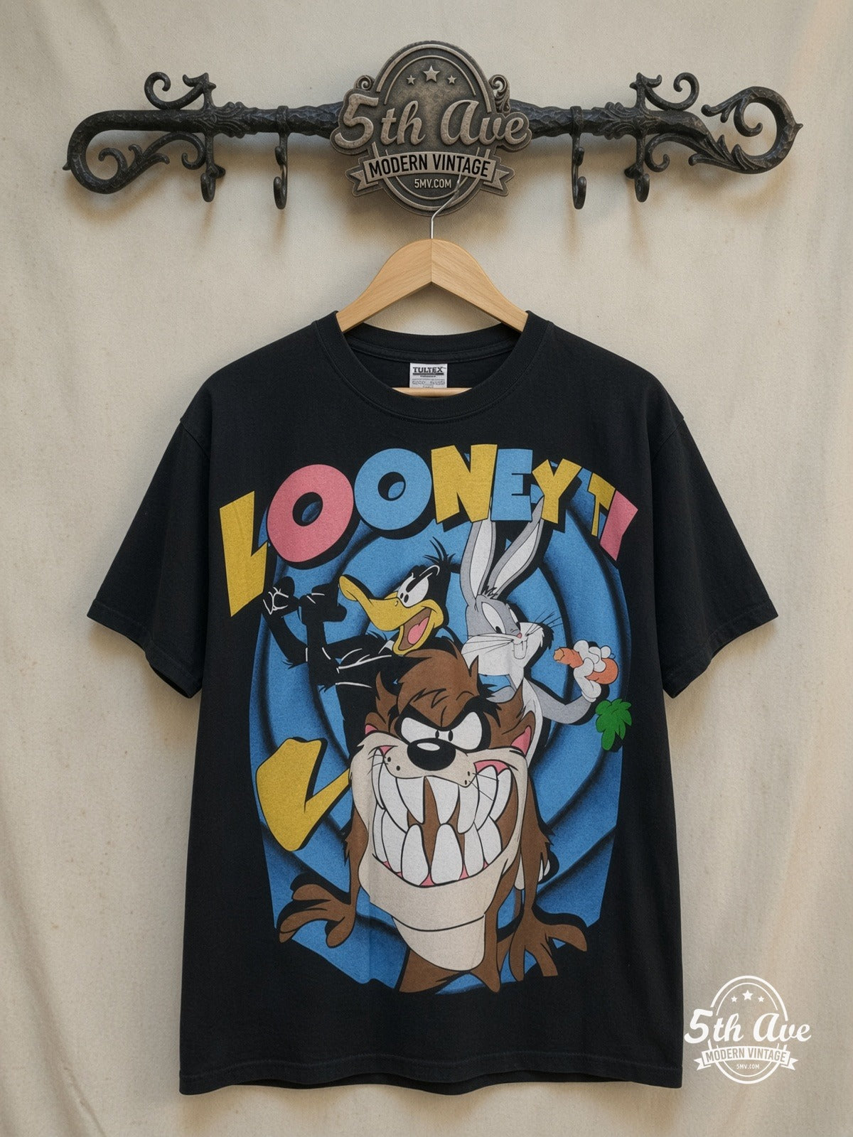 Bugs Bunny Looney Tunes Bugs Bunny Daffy Duck and Taz-Mania graphic tee, front view on a display rack