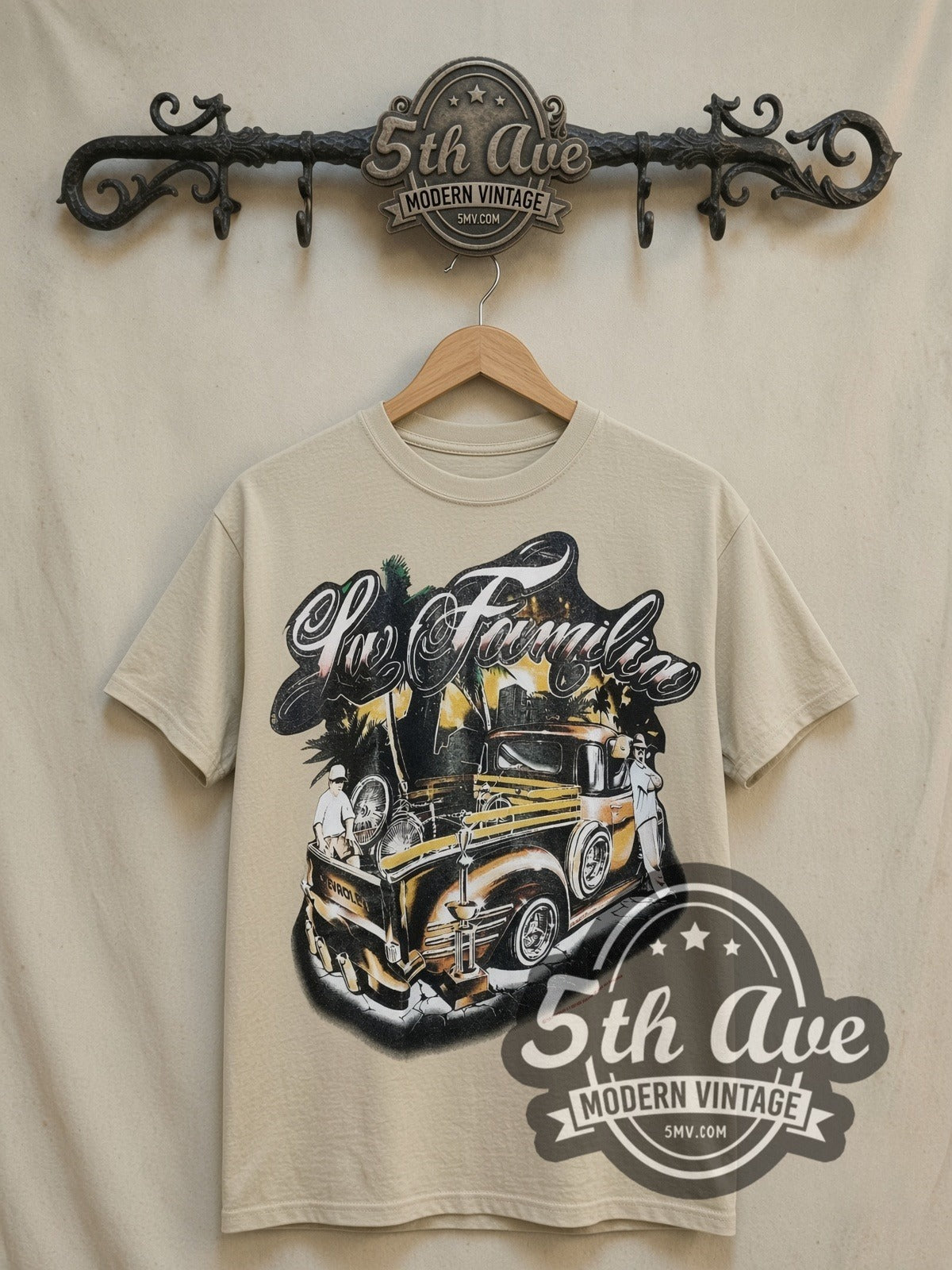Rollin Hard For Familia Lowrider vintage graphic tee in sand, front view on a display rack