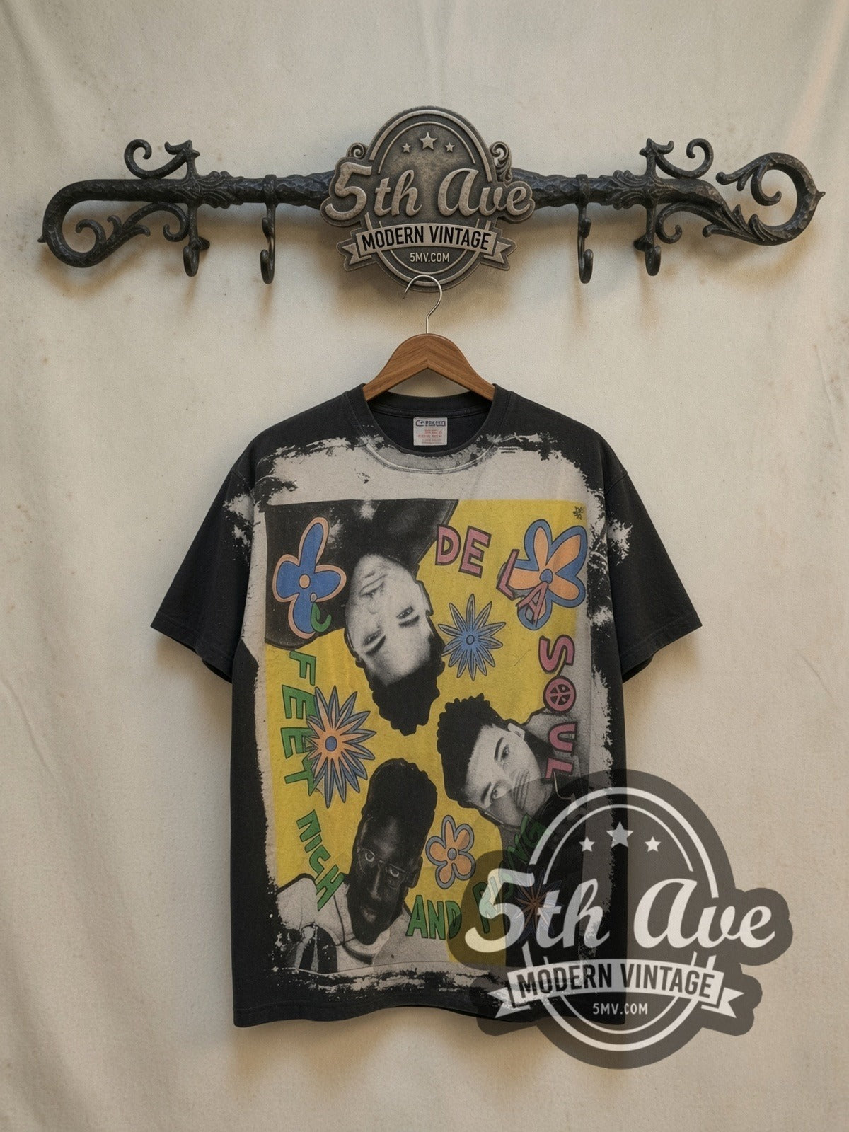 De La Soul all-over-print vintage rap tee, front view on a display rack