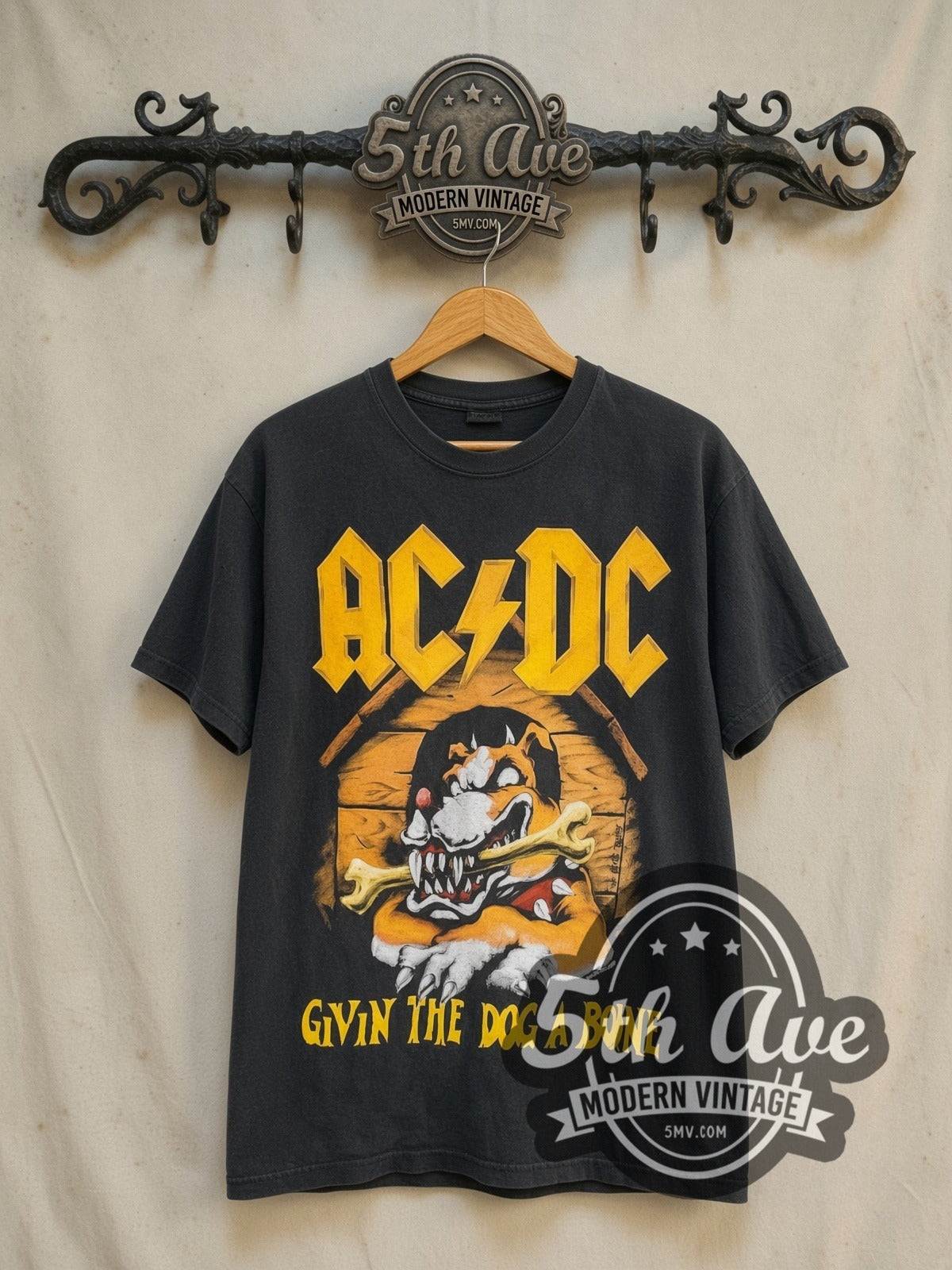 AC/DC Givin the Dog a Bone World Tour 1993 vintage band t-shirt in black, front view on a display rack