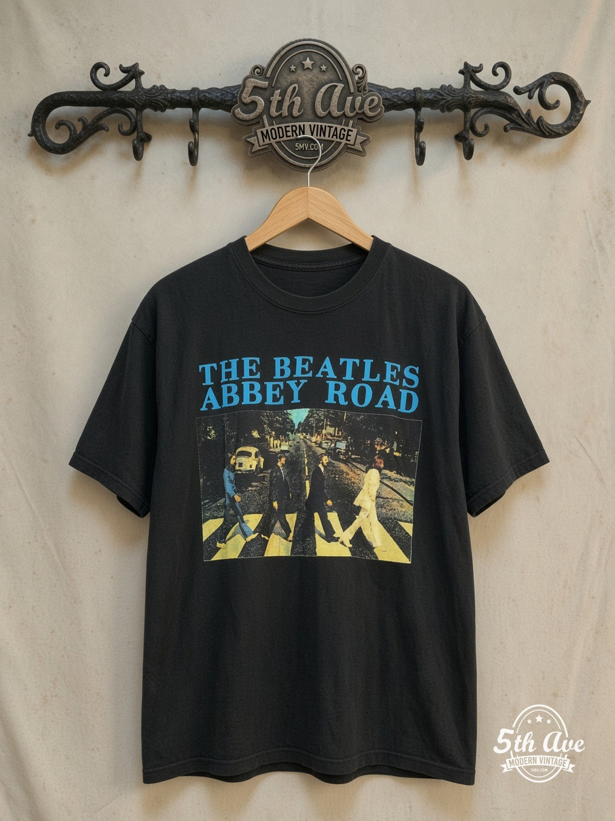 The Beatles – Abbey Road Crossing Cyan Logo – Vintage Band T-Shirt — front on locked cream ornate 5th Ave rack