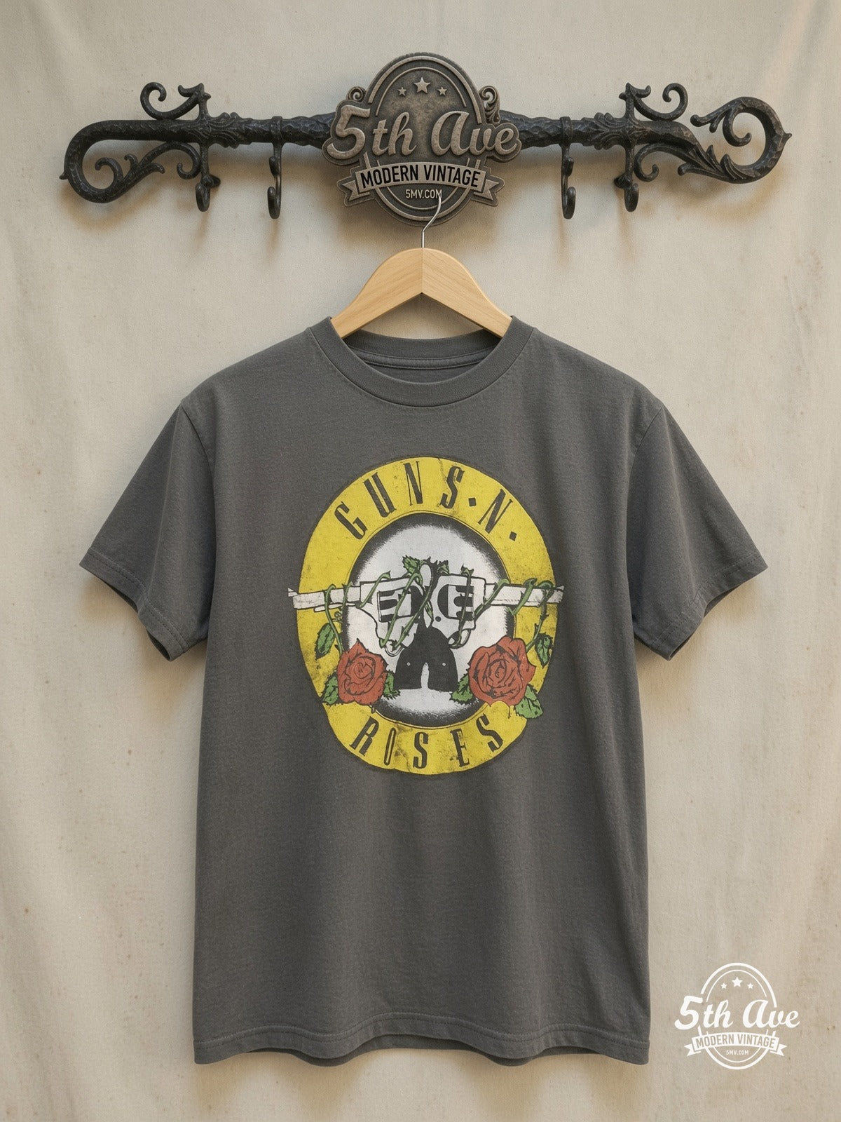 Rock 'n' Roll Elegance: Guns N' Roses Circular Logo T-Shirt – Vintage Band T-Shirt — front on locked cream ornate 5th Ave rack