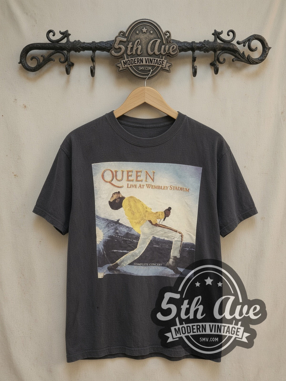 Queen Live at Wembley Stadium vintage band t-shirt, front view on a display rack