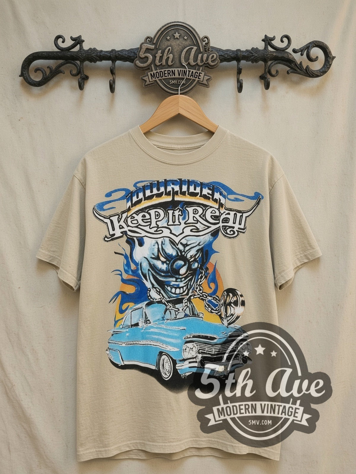 Rollin Hard Keep It Real Lowrider vintage graphic tee, front view on a display rack