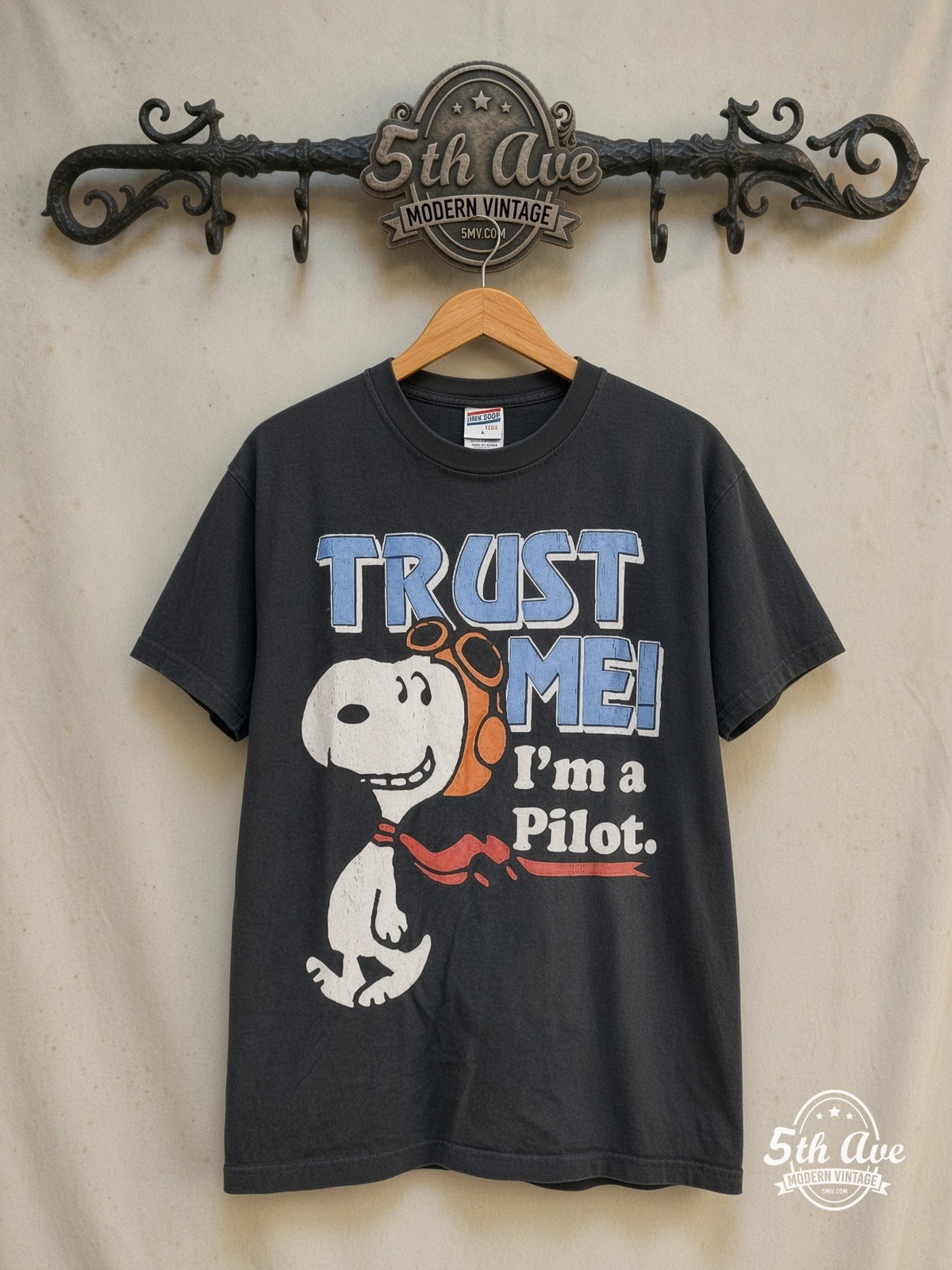 Peanuts – Snoopy Trust Me I'm a Pilot – New Vintage Graphic Tee — front on locked cream ornate 5th Ave rack