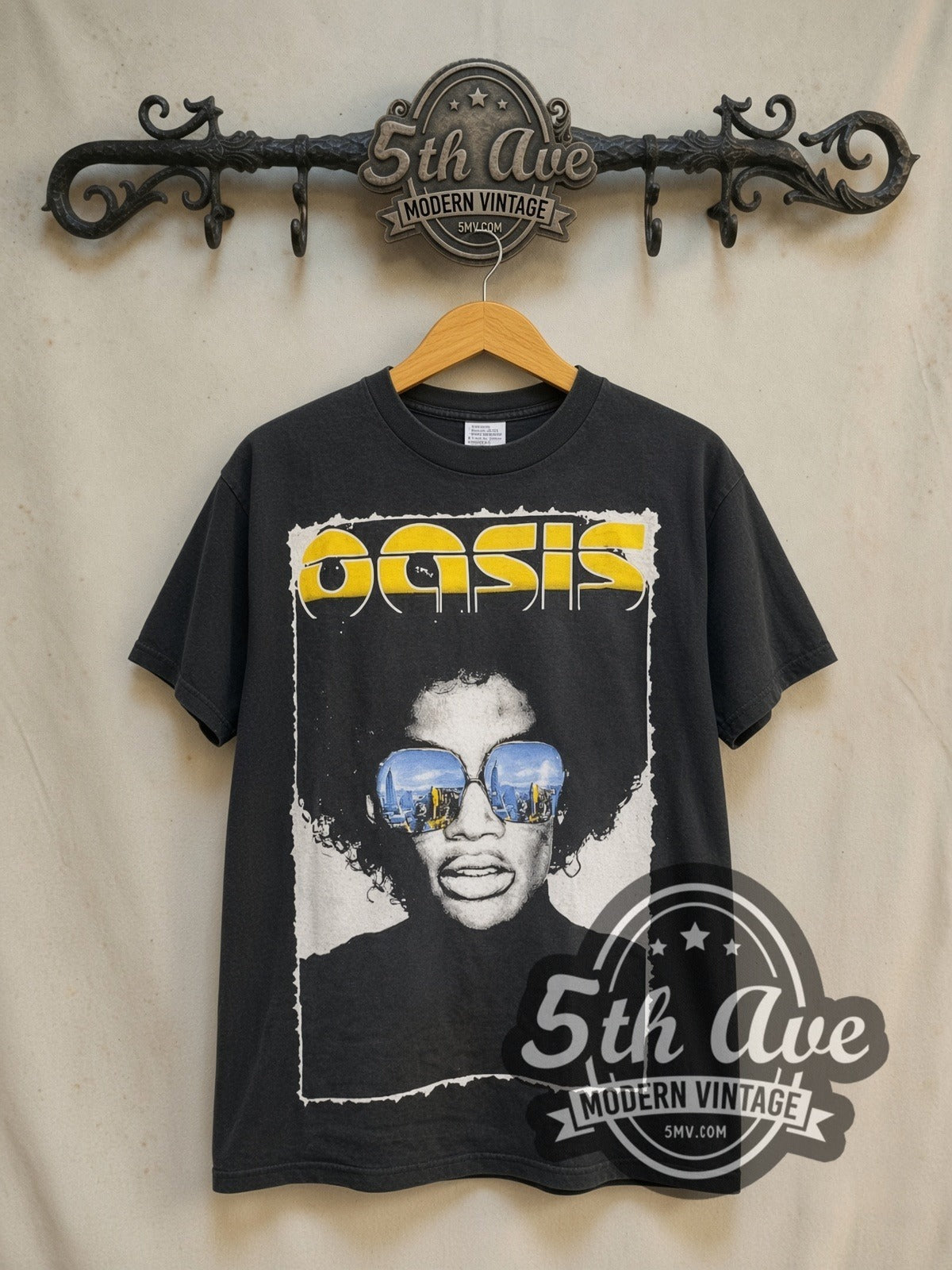 Oasis The Charlatans, Black Rebel Motorcycle Club, Proud Mary and vintage band t-shirt in black, front view on a display rack