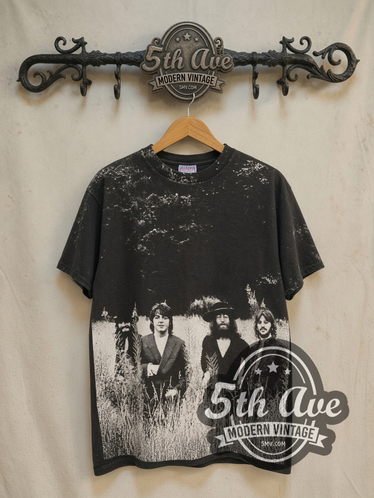 The Beatles Field of Grass 1995 all-over-print vintage band t-shirt in black, front view on a display rack