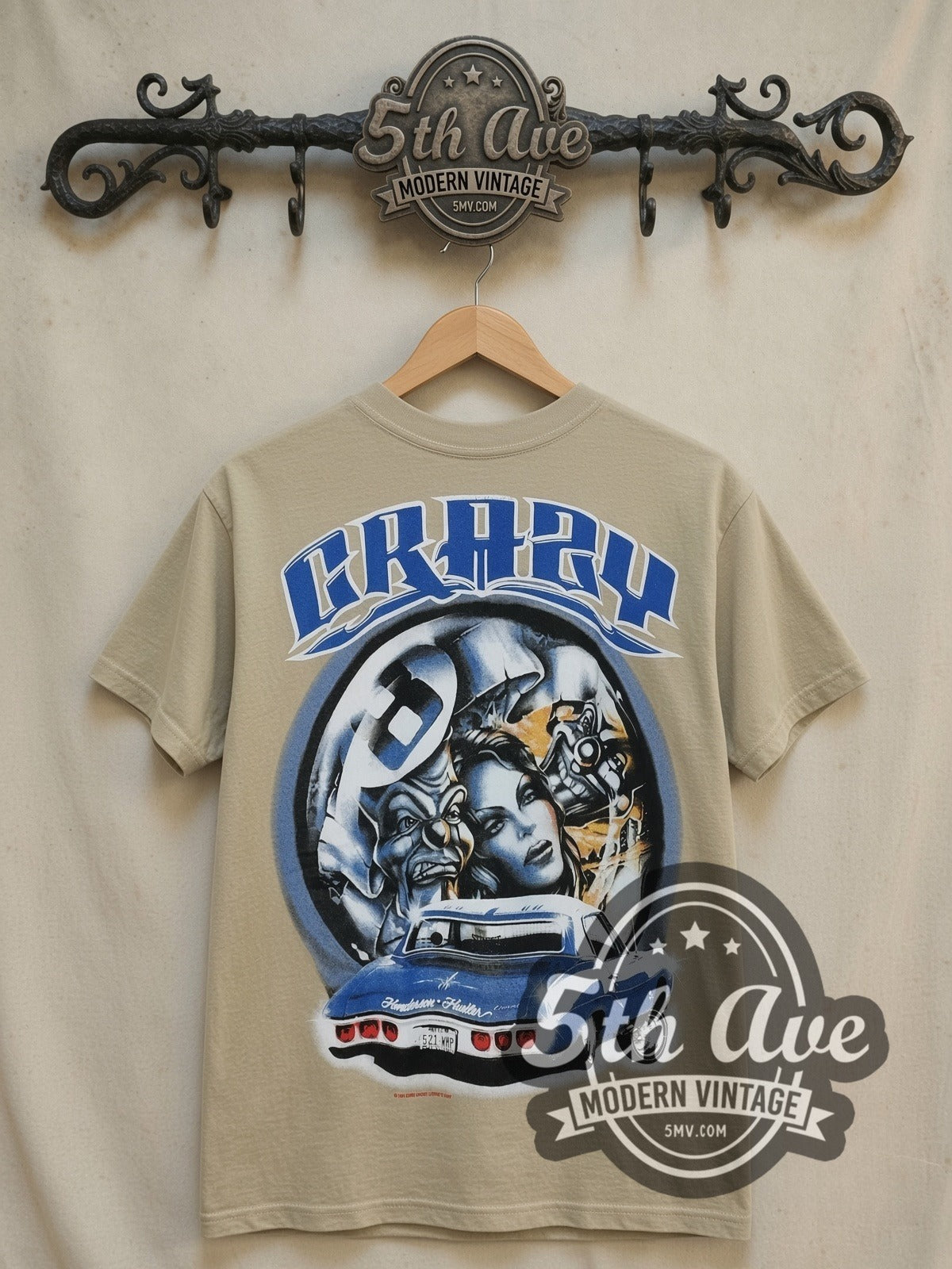 Rollin Hard Crazy Lowrider vintage graphic tee in sand, front view on a display rack