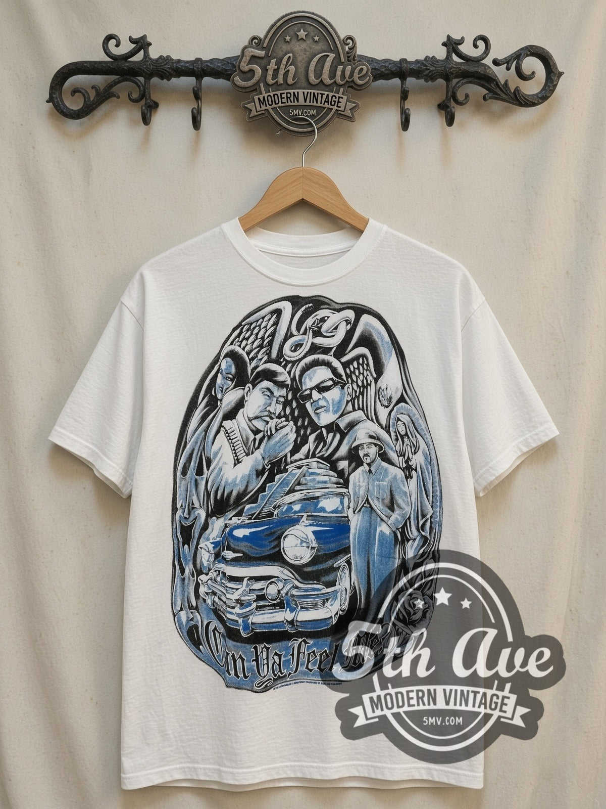 Rollin Hard Can Ya Feel Me? Lowrider vintage graphic tee, front view on a display rack