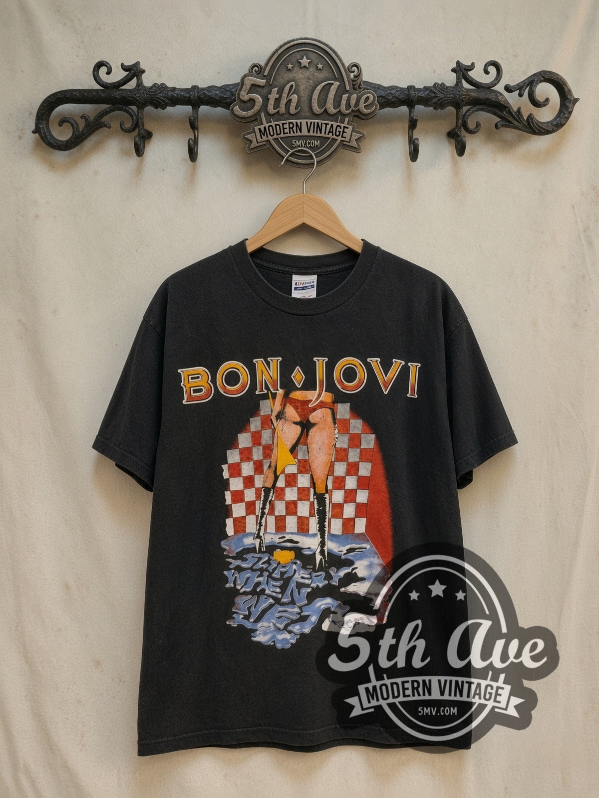 Bon Jovi Slippery When Wet / Let It Rock 1986 vintage band t-shirt in black, front view on a display rack