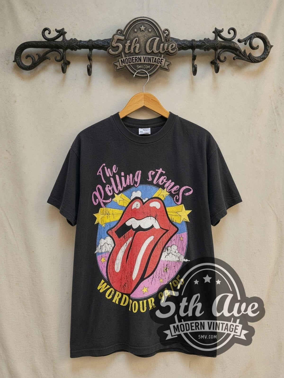 The Rolling Stones World Tour 1994/1995 vintage band t-shirt in black, front view on a display rack