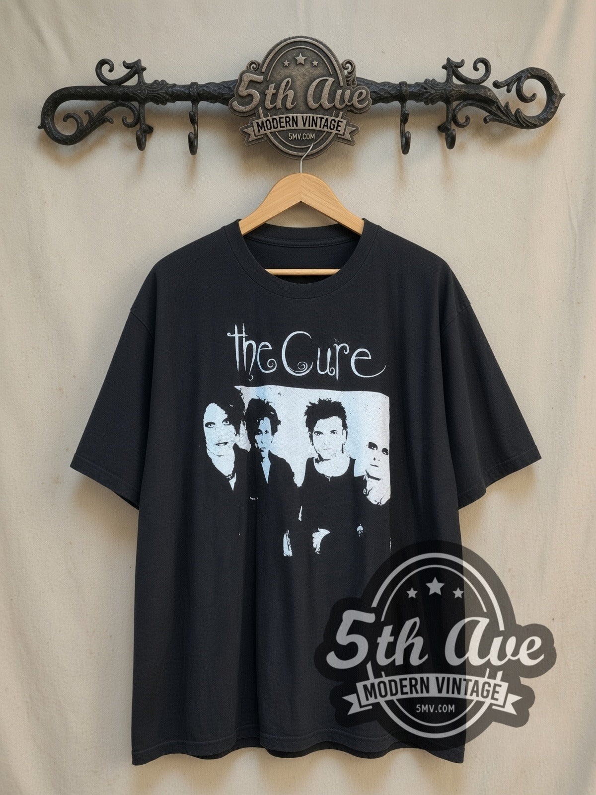 The Cure Four Member Photo White Script vintage band t-shirt in white, front view on a display rack