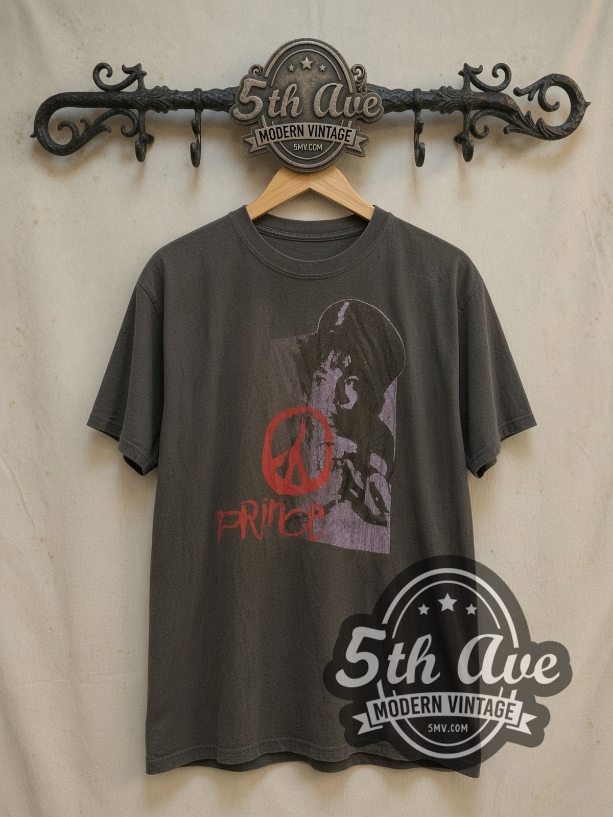 Prince Purple Portrait Red Peace Sign vintage band t-shirt, front view on a display rack