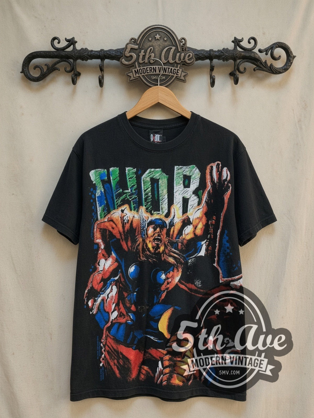 Marvel Thor Odinson Mjolnir Comic all-over-print vintage comic tee in black, front view on a display rack