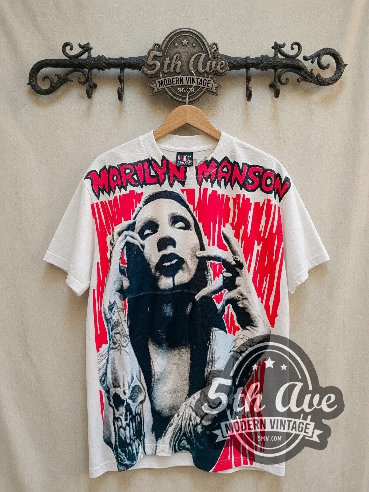 Marilyn Manson all-over-print vintage band t-shirt, front view on a display rack