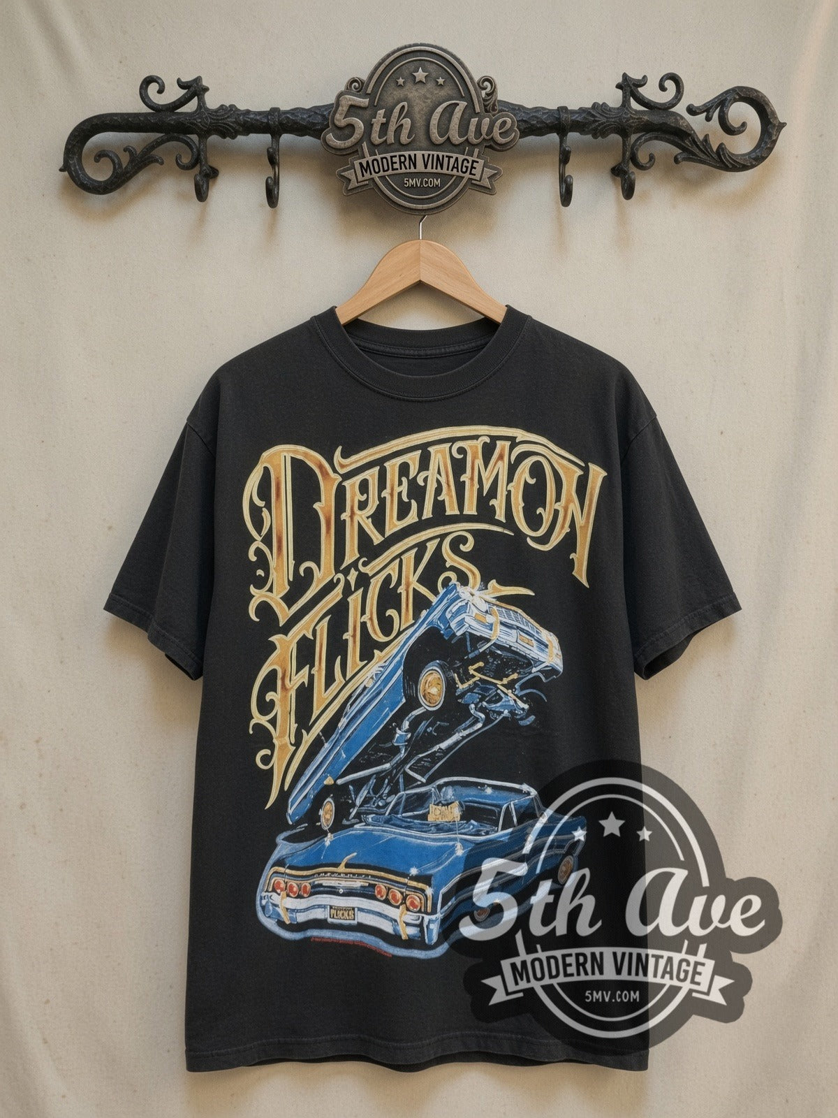 Rollin Hard Lowrider Dreams and Hydraulic Scenes vintage graphic tee, front view on a display rack
