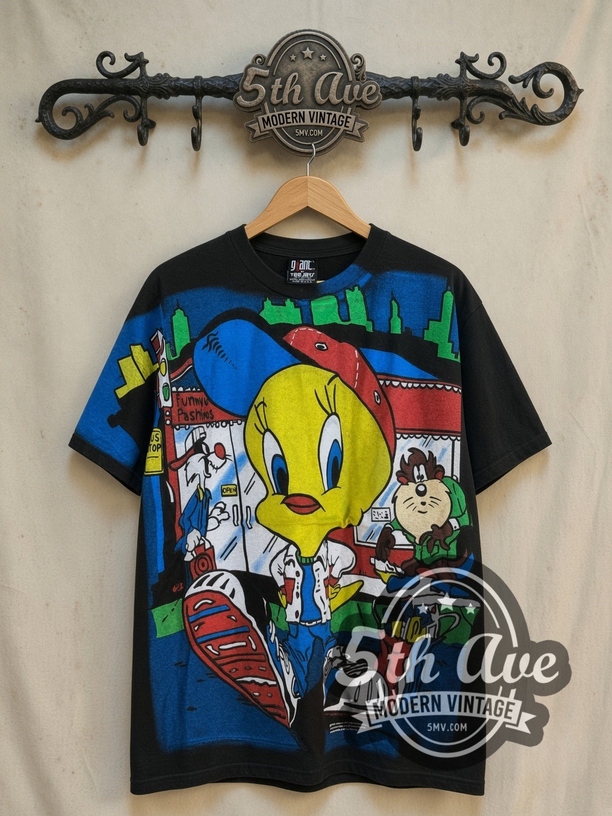 Looney Tunes Tweety, Sylvester and Taz-Mania all-over-print vintage cartoon tee, front view on a display rack