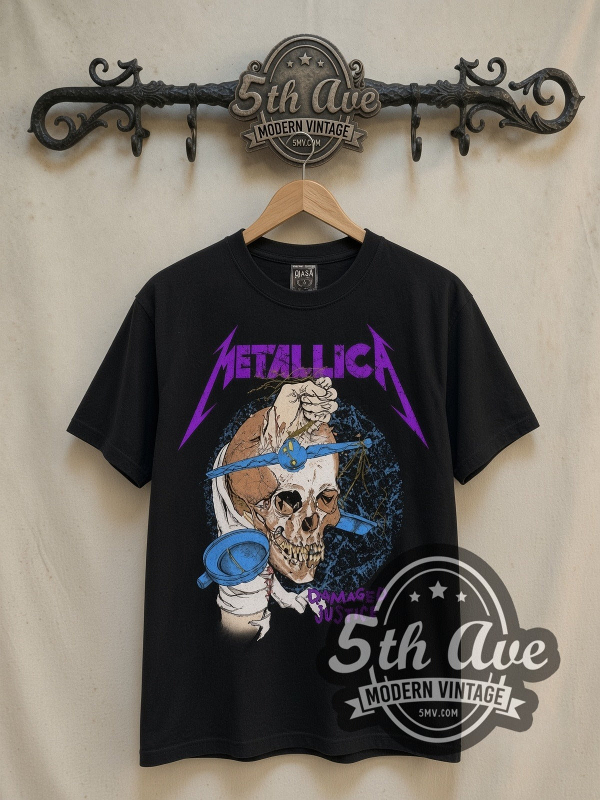 Metallica Damaged Justice Skull Scales vintage band t-shirt in black, front view on a display rack