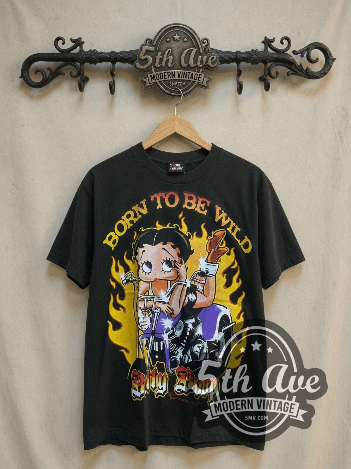 Betty Boop Born to Be Wild Biker graphic tee, front view on a display rack