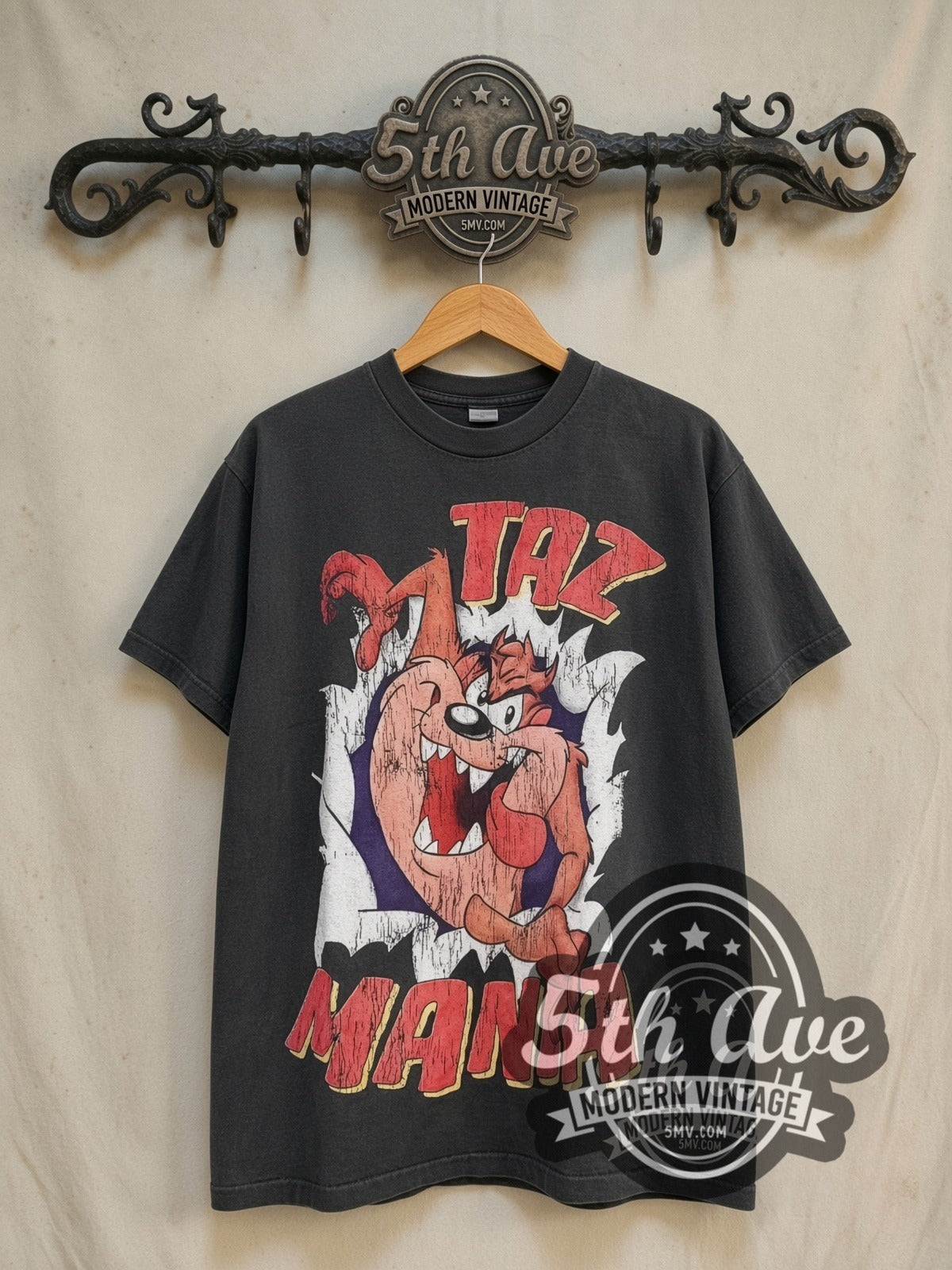Looney Tunes Taz-Mania Back Off vintage cartoon tee in black, front view on a display rack