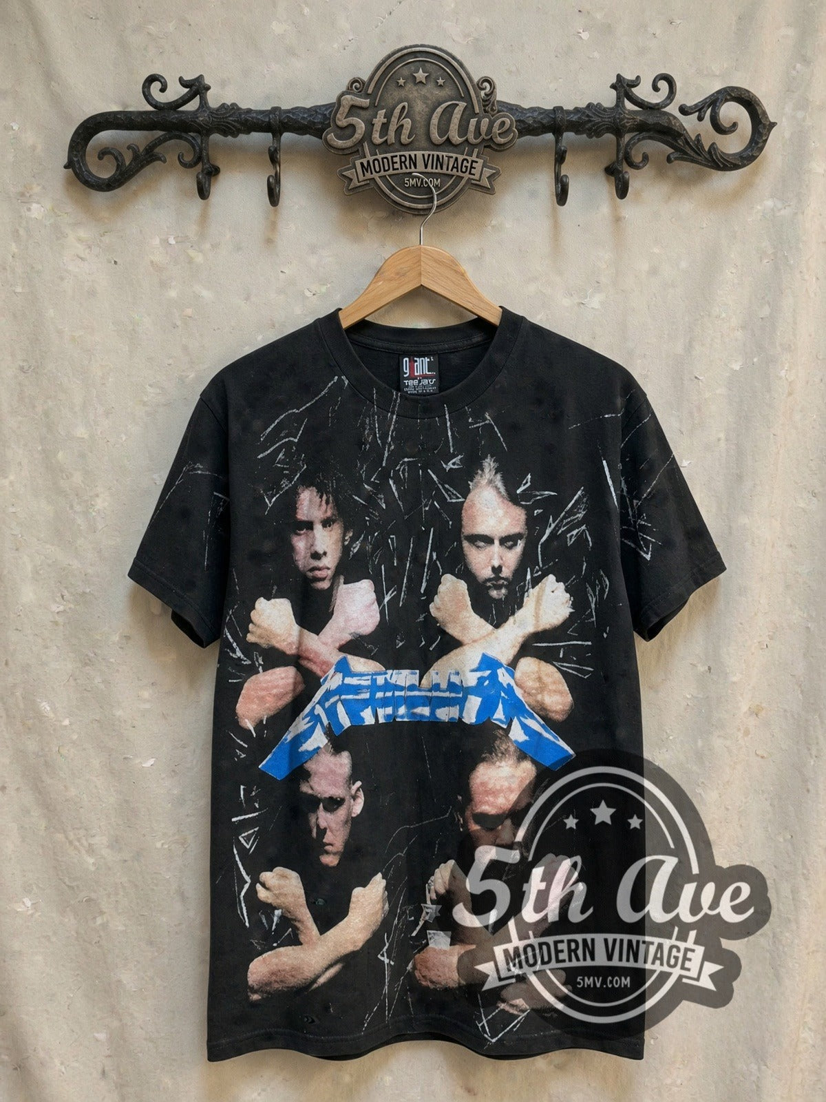 Metallica Unleash the Metal all-over-print vintage band t-shirt, front view on a display rack