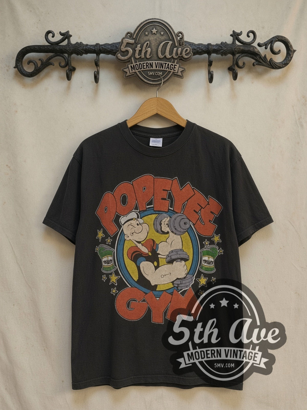 Popeye Spinach graphic tee, front view on a display rack