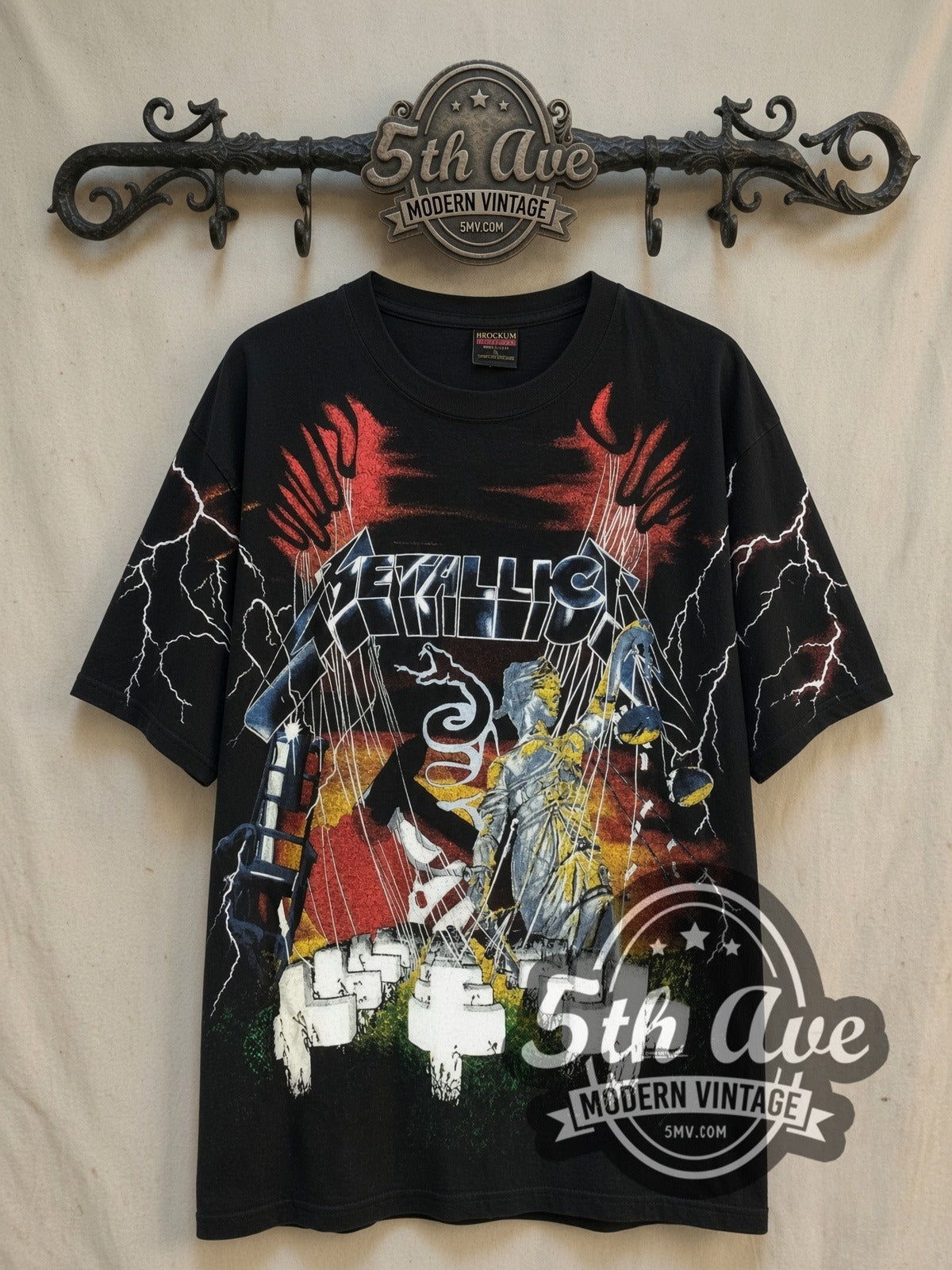 Metallica Master of Puppets vintage band t-shirt, front view on a display rack