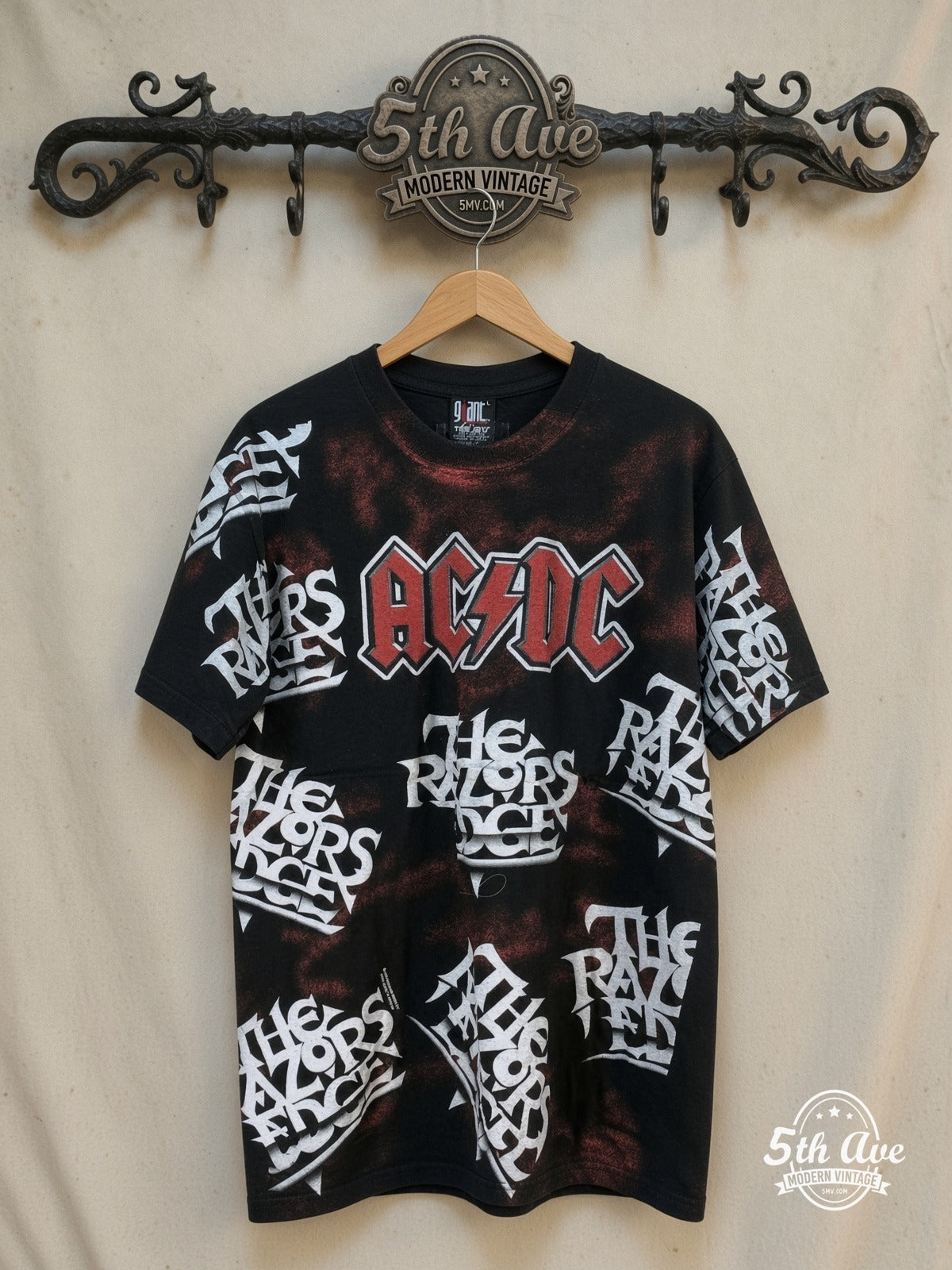 AC/DC – Electrifying Energy: The AC/DC "Razor's Edge" All-Over Print t shirt i – Vintage Band T-Shirt — front on locked cream ornate 5th Ave rack