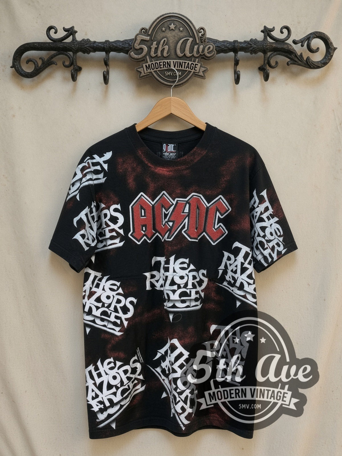 AC/DC The Razors Edge all-over-print vintage band t-shirt, front view on a display rack