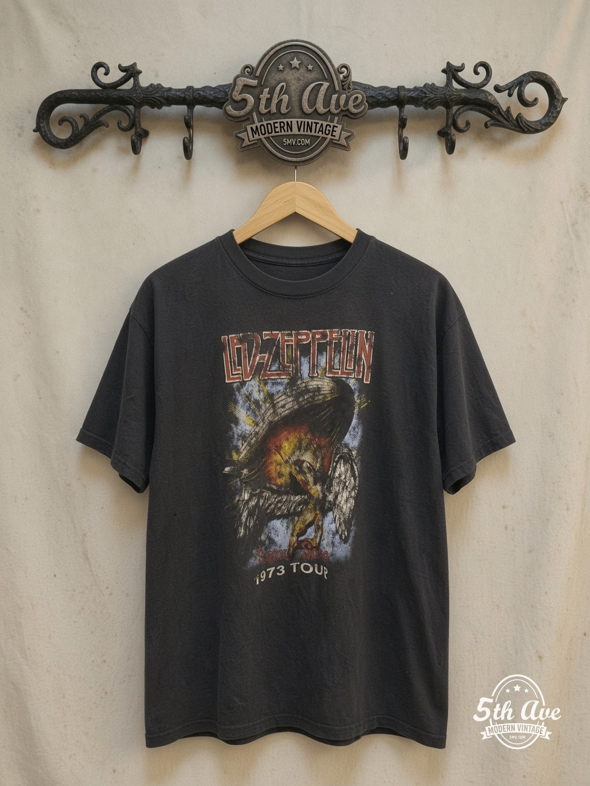 Led Zeppelin – 1973 Tour Angel & Zeppelin Black – Vintage Band T-Shirt — front on locked cream ornate 5th Ave rack