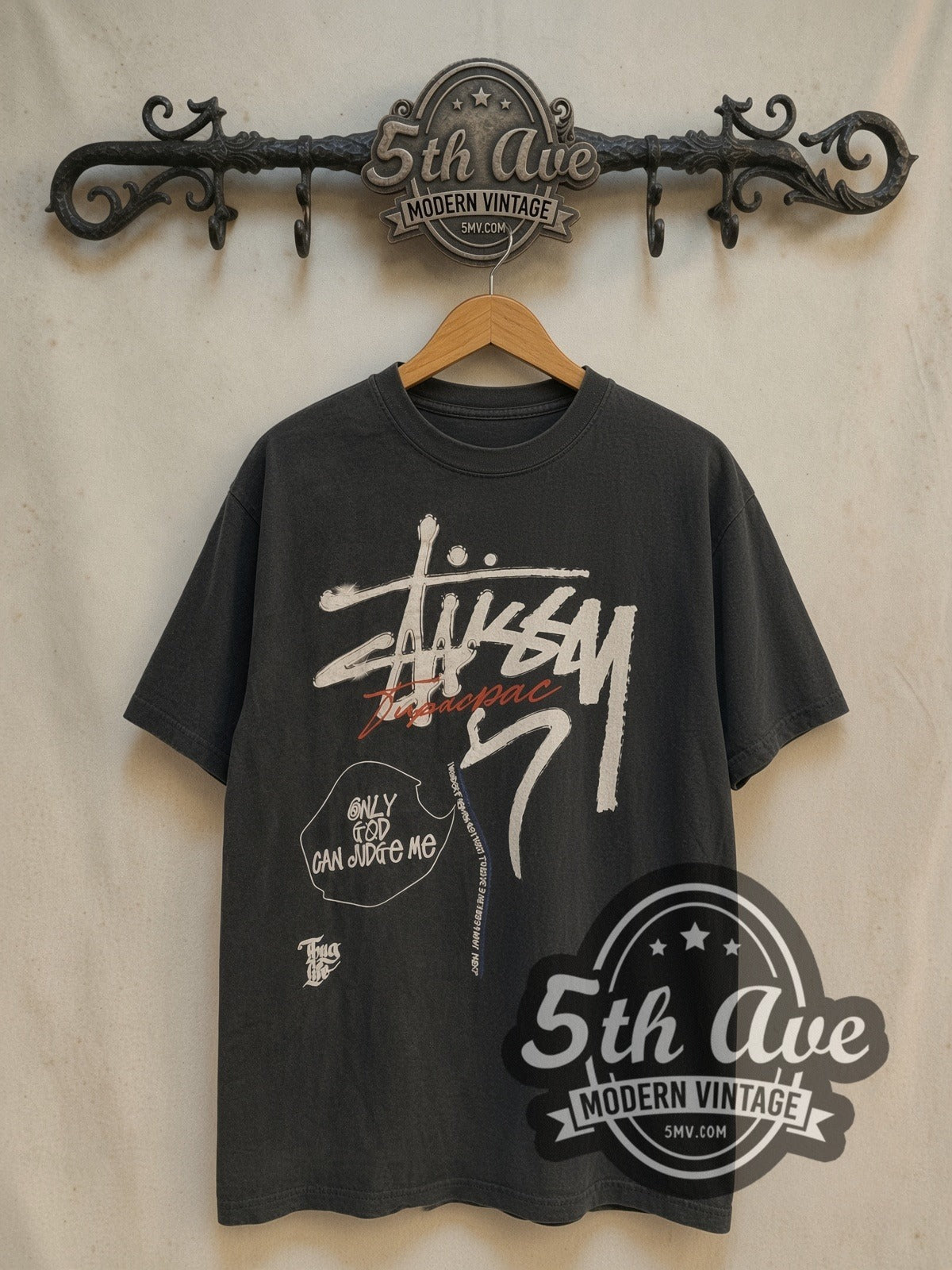 Tupac × Stüssy Only God Can Judge Me vintage band t-shirt, front view on a display rack