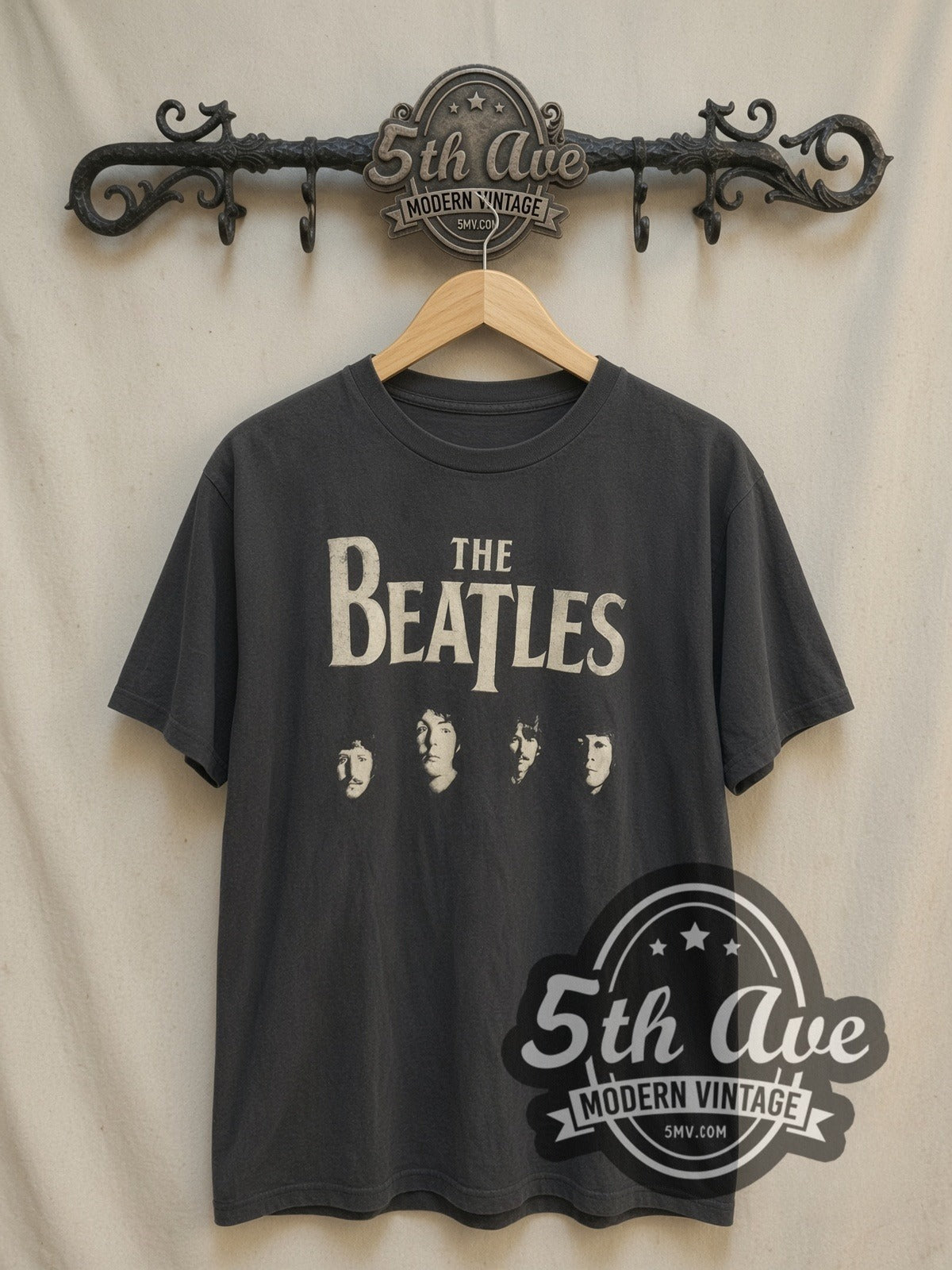 The Beatles Four Faces Classic Logo vintage band t-shirt, front view on a display rack