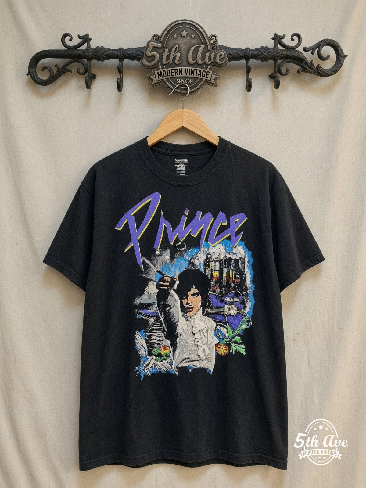 Prince and the Revolution vintage band t-shirt, front view on a display rack
