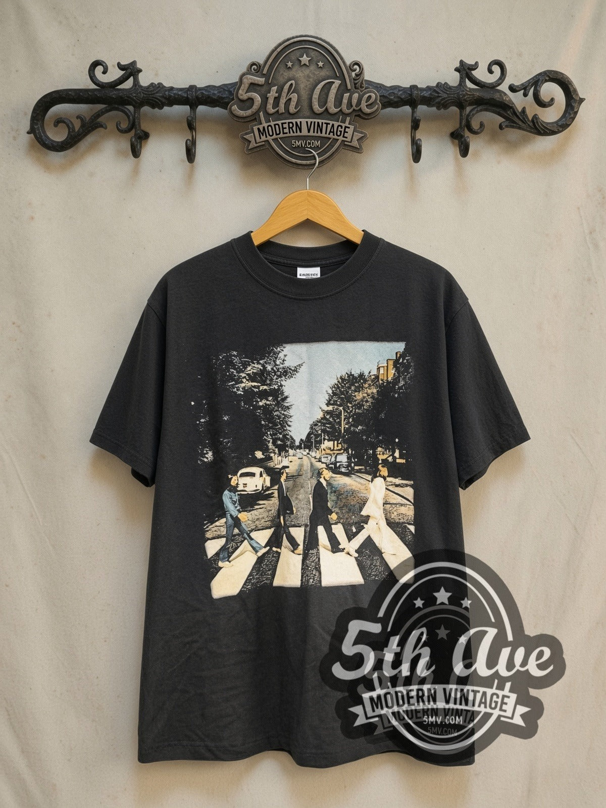 The Beatles Abbey Road Crossing Wall Sign Back vintage band t-shirt in black, front view on a display rack