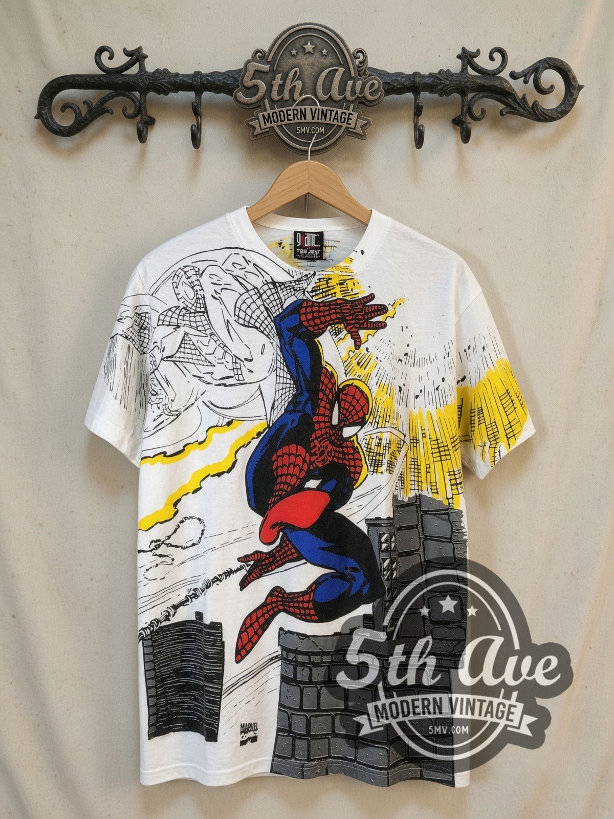 Marvel Spider-Man all-over-print vintage comic tee, front view on a display rack
