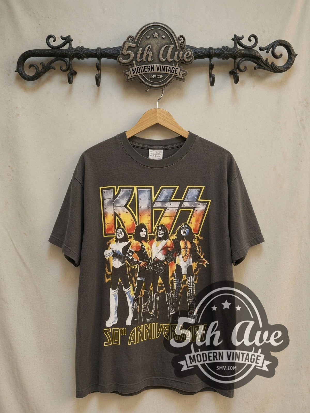 KISS 50th Anniversary vintage band t-shirt, front view on a display rack