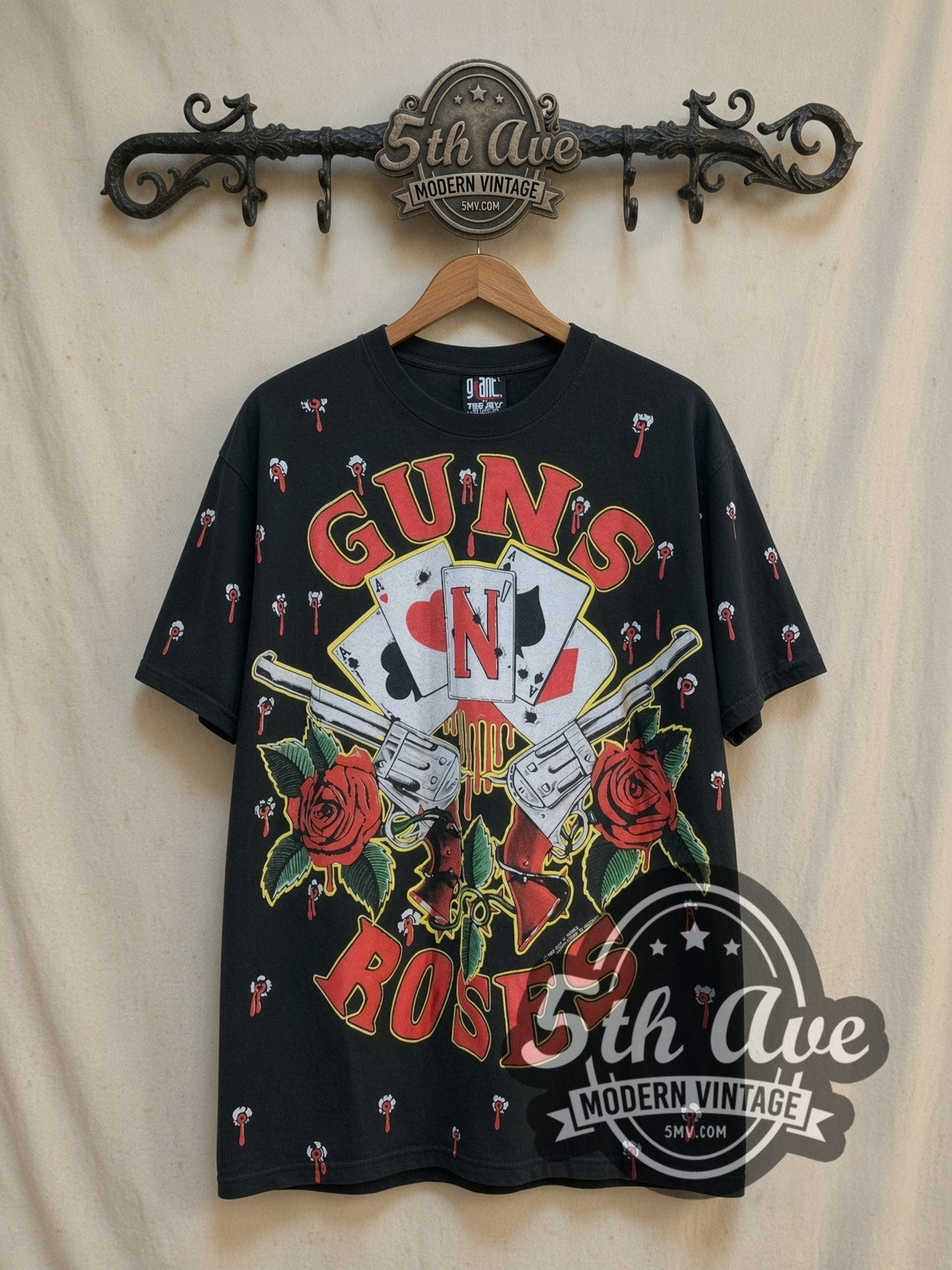 Guns N' Roses Crossed Guns Roses Aces all-over-print vintage band t-shirt, front view on a display rack