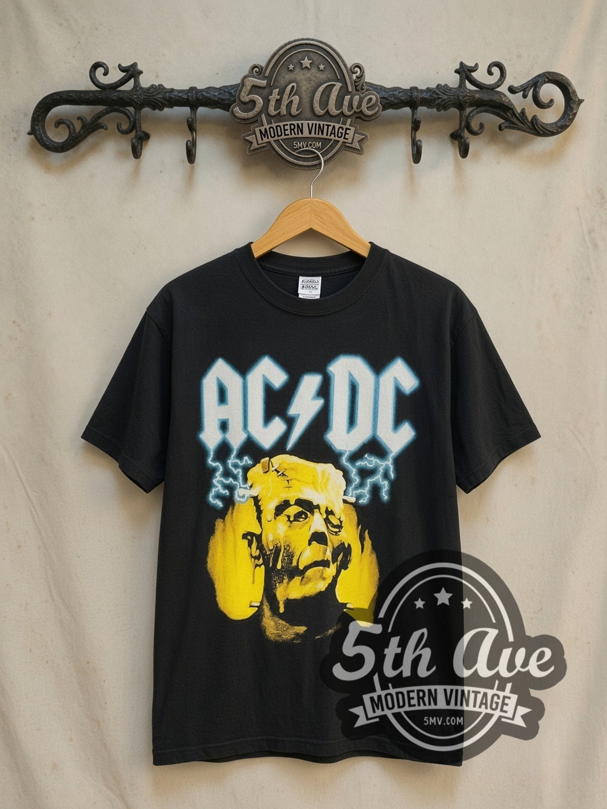 AC/DC Meltdown vintage band t-shirt in black, front view on a display rack