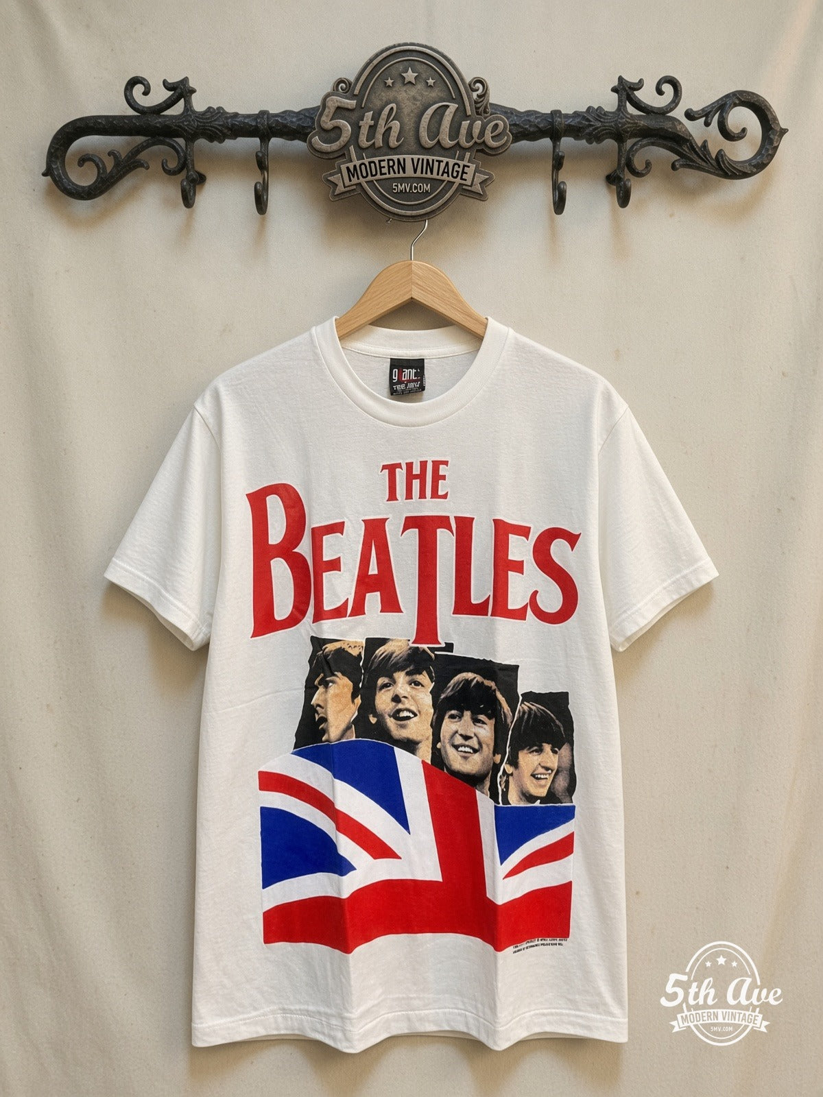 The Beatles Union Jack Red Logo White vintage band t-shirt in white, front view on a display rack