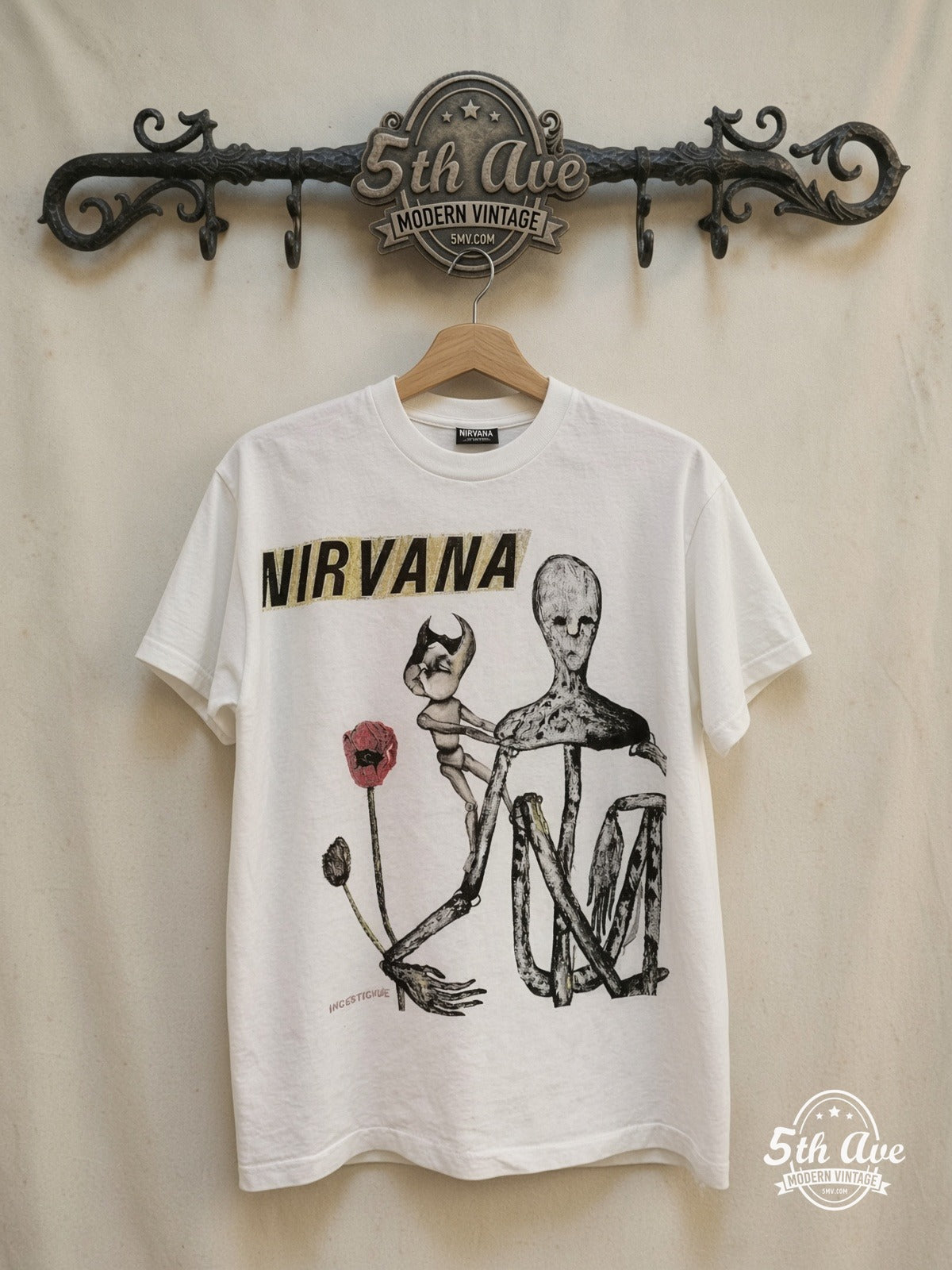 Nirvana – Insecticide – Vintage Band T-Shirt — front on locked cream ornate 5th Ave rack