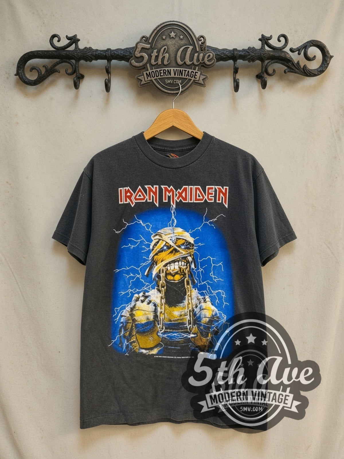 Iron Maiden World Slavery Tour' 1984/85 vintage band t-shirt in black, front view on a display rack