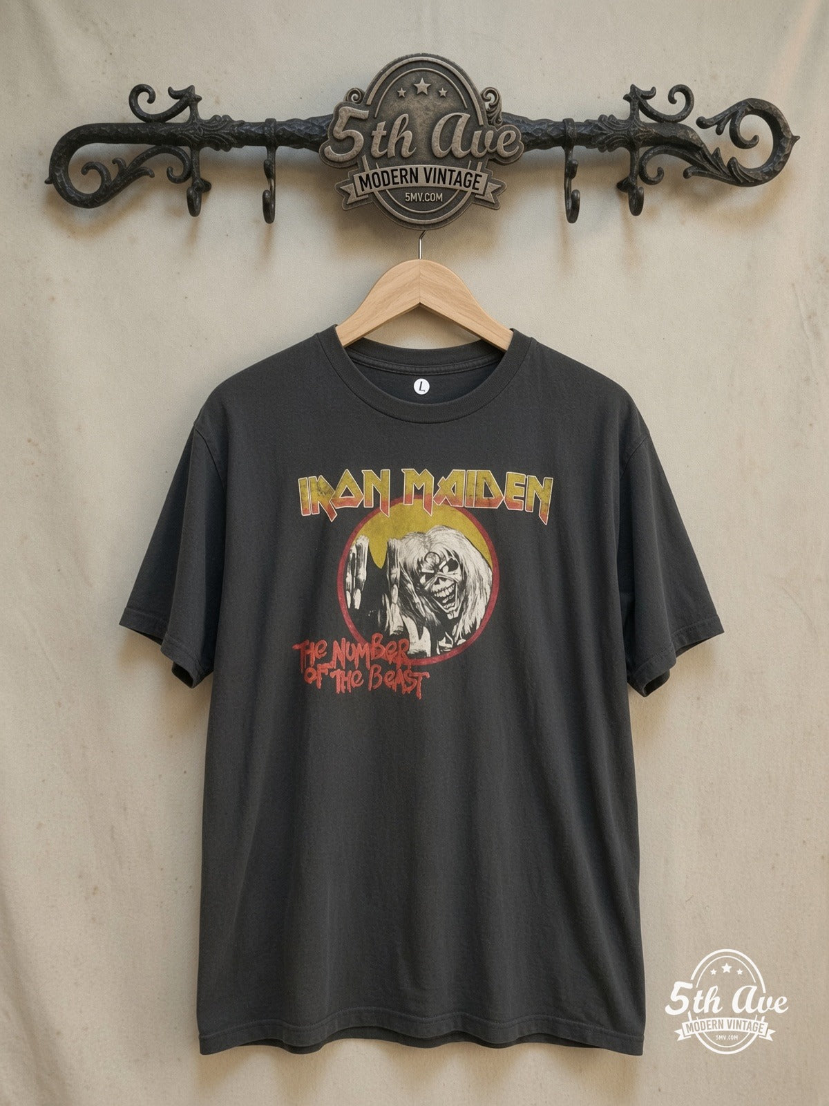 Iron Maiden – Heavy Metal Legacy: Iron Maiden 'Number of the Beast' Vintage Band Tee – Vintage Band T-Shirt — front on locked cream ornate 5th Ave rack