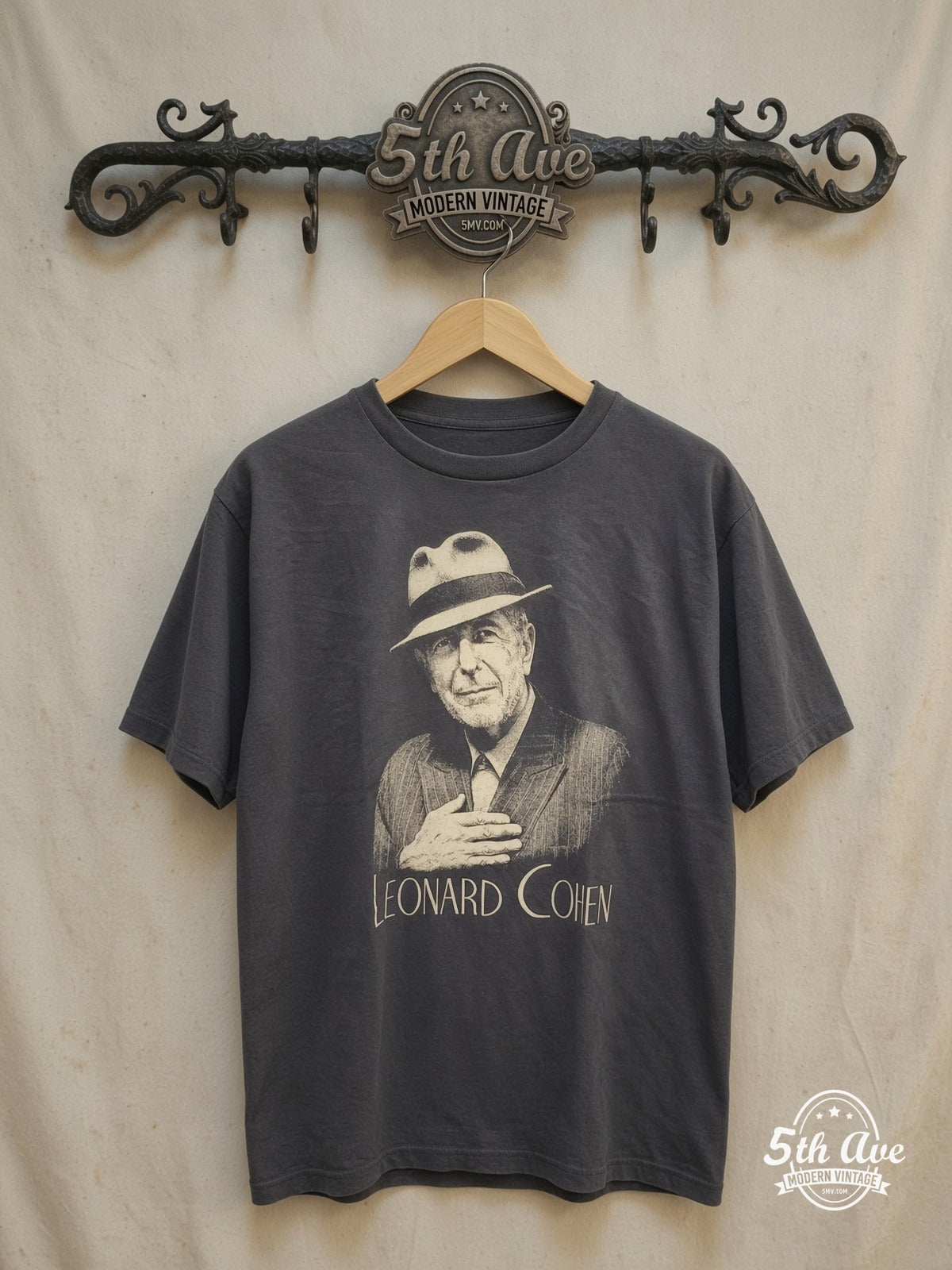 Leonard Cohen – Inspired Portrait Cotton – Vintage Band T-Shirt — front on locked cream ornate 5th Ave rack