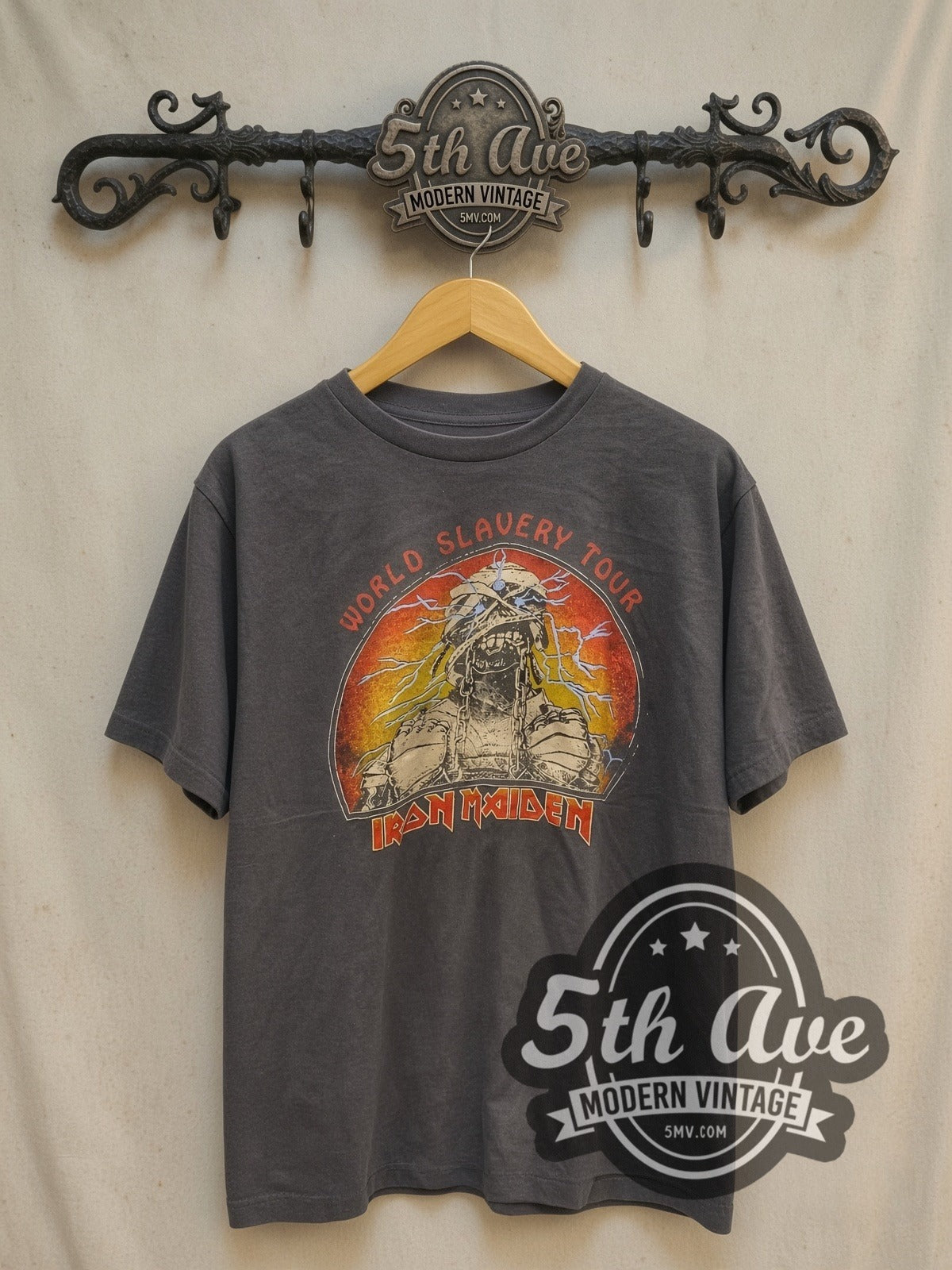 Iron Maiden World Slavery Tour vintage band t-shirt, front view on a display rack
