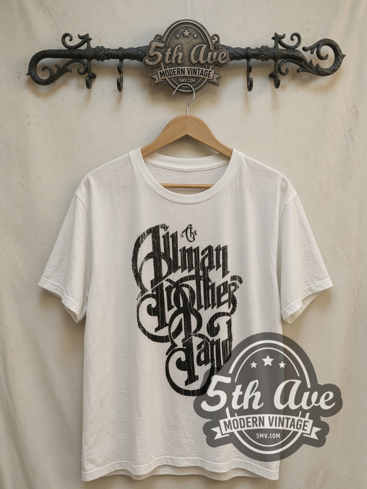 The Allman Brothers Band Black Distressed Script Logo vintage band t-shirt in white, front view on a display rack