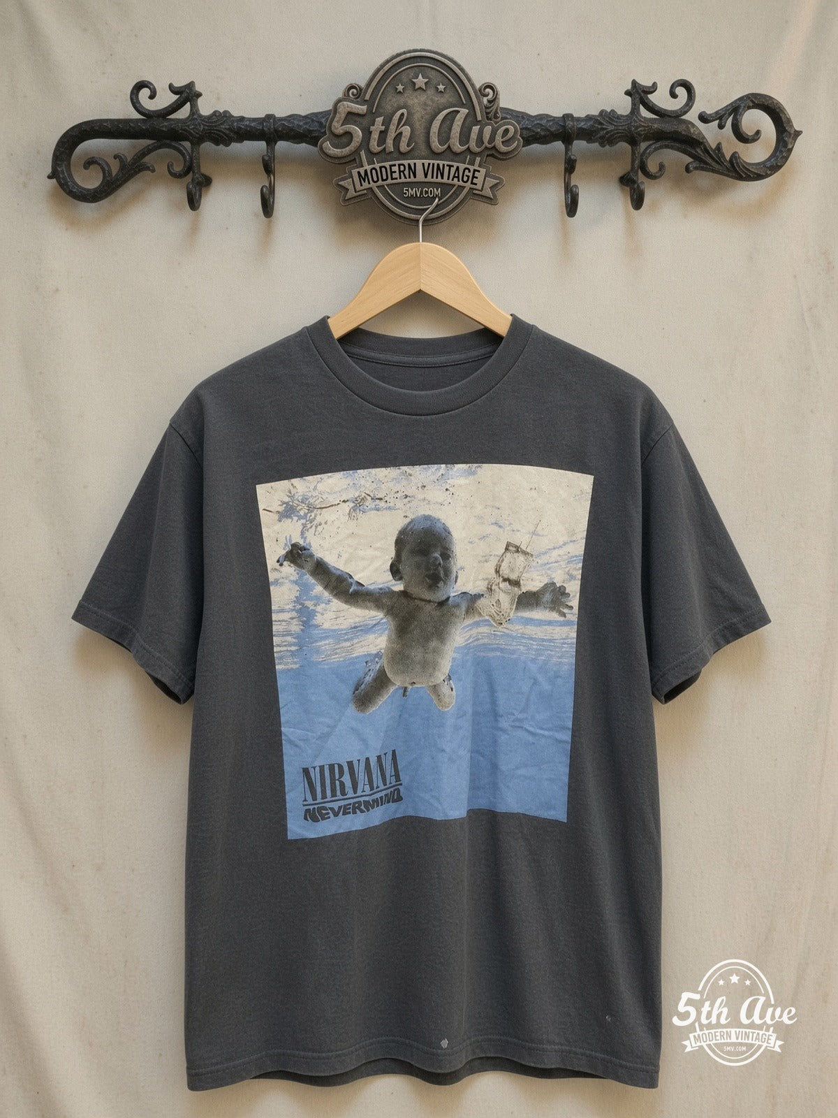 Nirvana – Nevermind Baby Cover – Vintage Band T-Shirt — front on locked cream ornate 5th Ave rack