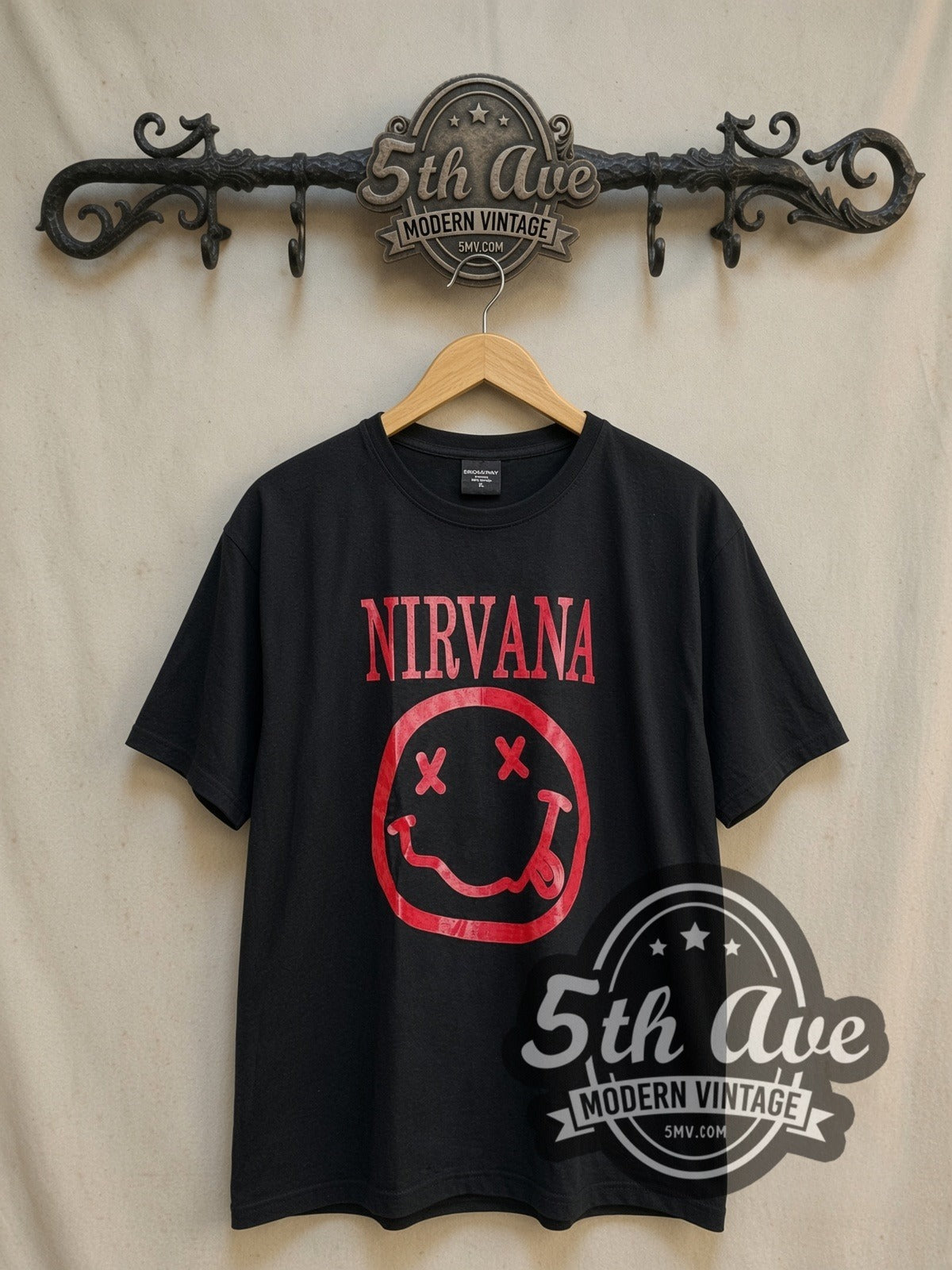 Nirvana Red Smiley Face Logo vintage band t-shirt, front view on a display rack