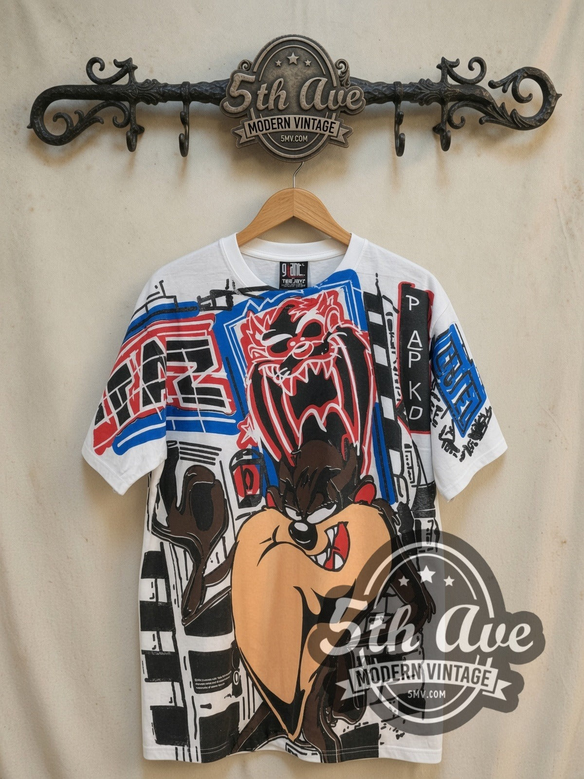 Looney Tunes Taz-Mania Graphic Art all-over-print vintage cartoon tee, front view on a display rack
