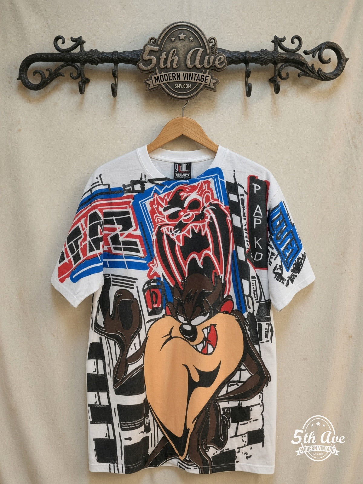 Looney Tunes – Taz-Mania Graphic Art – All Over Print – New Vintage Graphic Tee — front on locked cream ornate 5th Ave rack