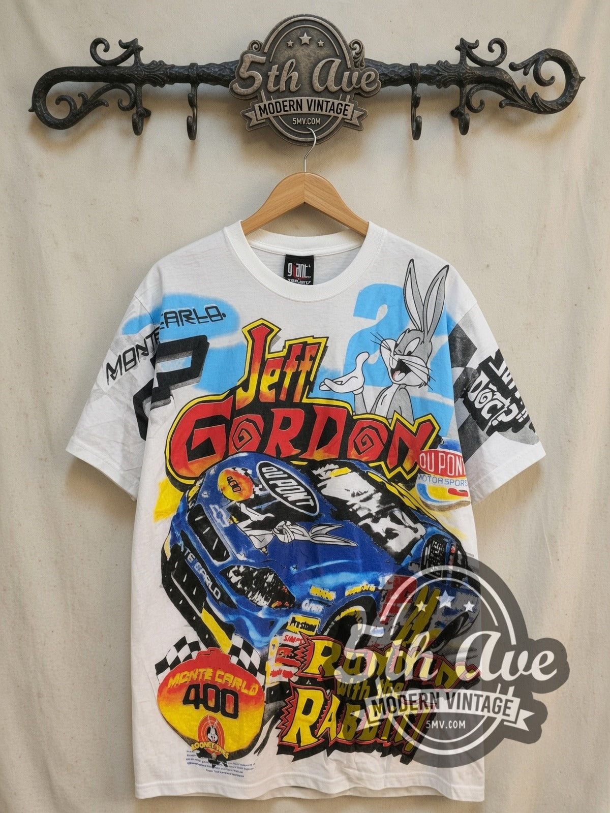 NASCAR Bugs Bunny and Jeff Gordon all-over-print vintage graphic t-shirt, front view on a display rack